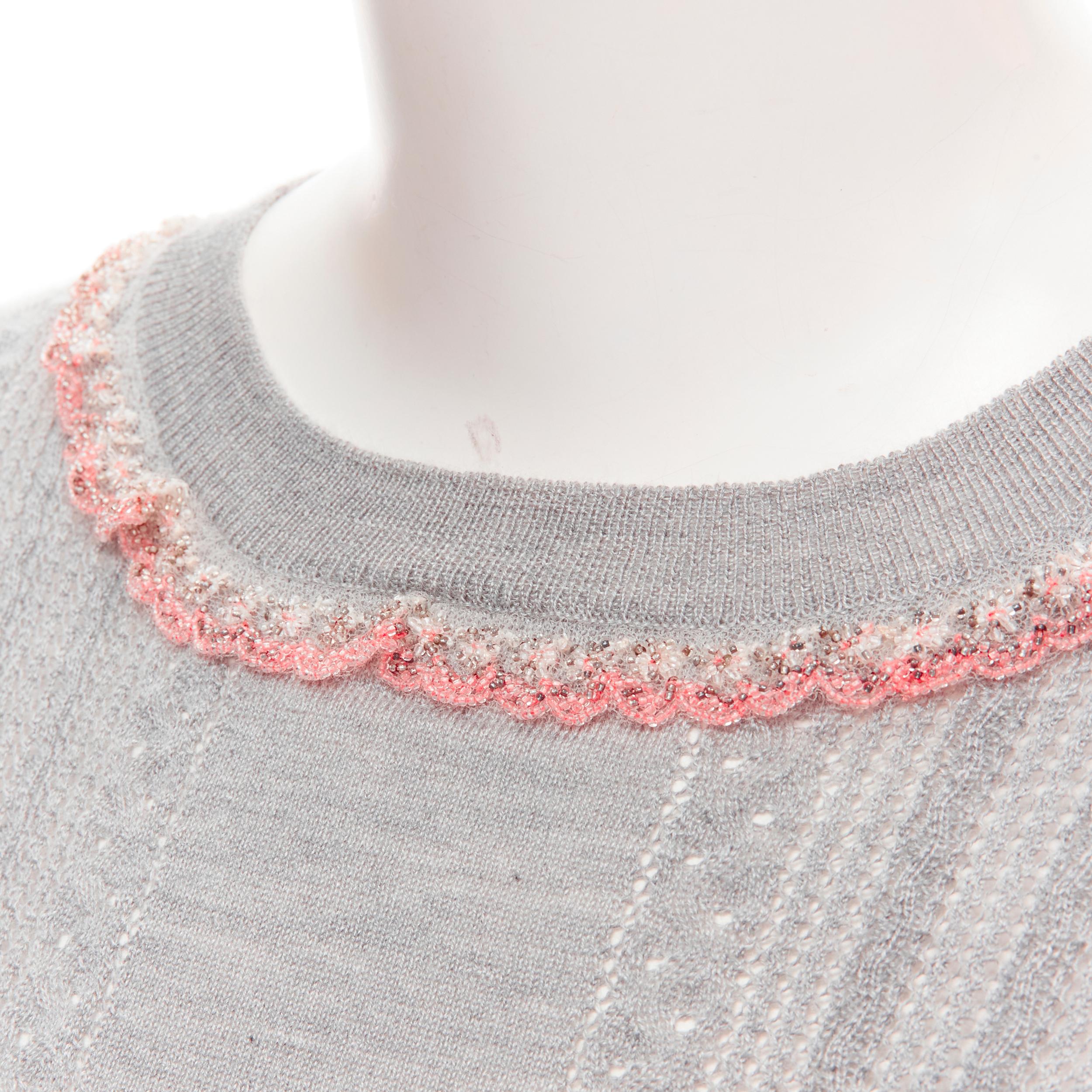 new MIU MIU grey cashmere silk pink floral beaded scalloped trim pullover sweater IT42 S 
Reference: MELK/A00042 
Brand: Miu Miu 
Collection: 2018 
Material: Cashmere 
Color: Grey 
Pattern: Solid 
Closure: Button 
Extra Detail: Pink and white floral