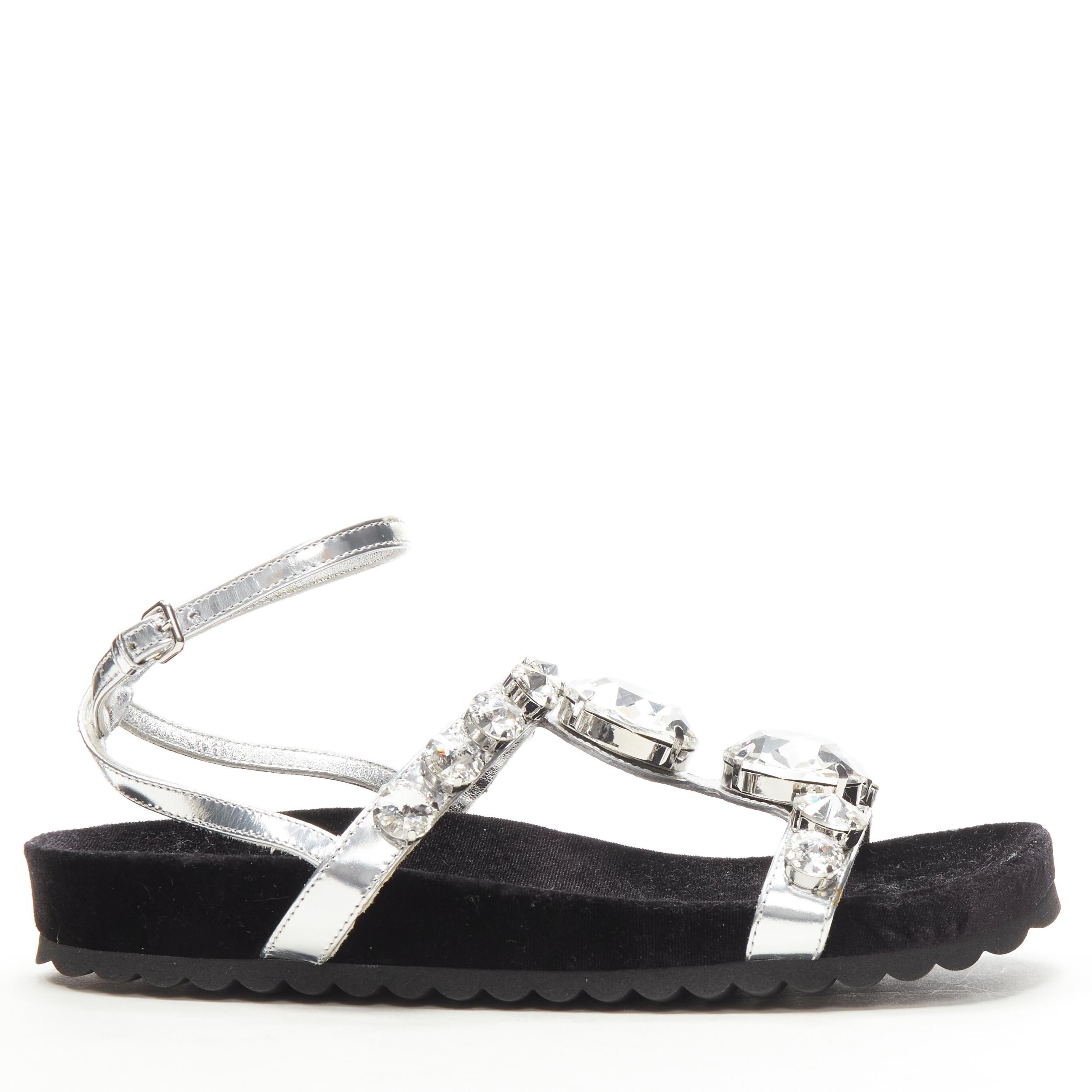 new MIU MIU large rhinestone crystal metallic silver velvet flat sandals EU37.5
Brand: Miu Miu
Designer: Miuccia Prada
Model: 5X608C
Material: Leather
Color: Silver
Pattern: Solid
Closure: Ankle Strap
Extra Detail: Metallic silver leather strappy