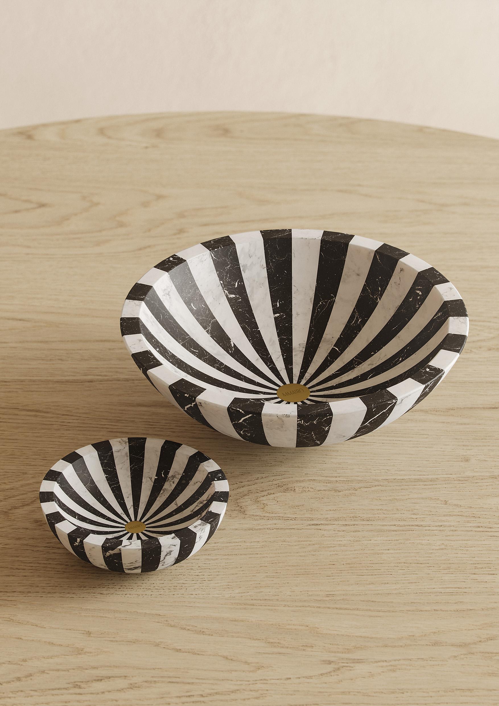Bowl L in White Michelangelo and Black Marquinia marble 
Available also in the S version, and with a rotating mechanism.

The hypnotic black and white stripes of the new Nova collection, designed by Jacopo Simonetti, offer a versatile way to add