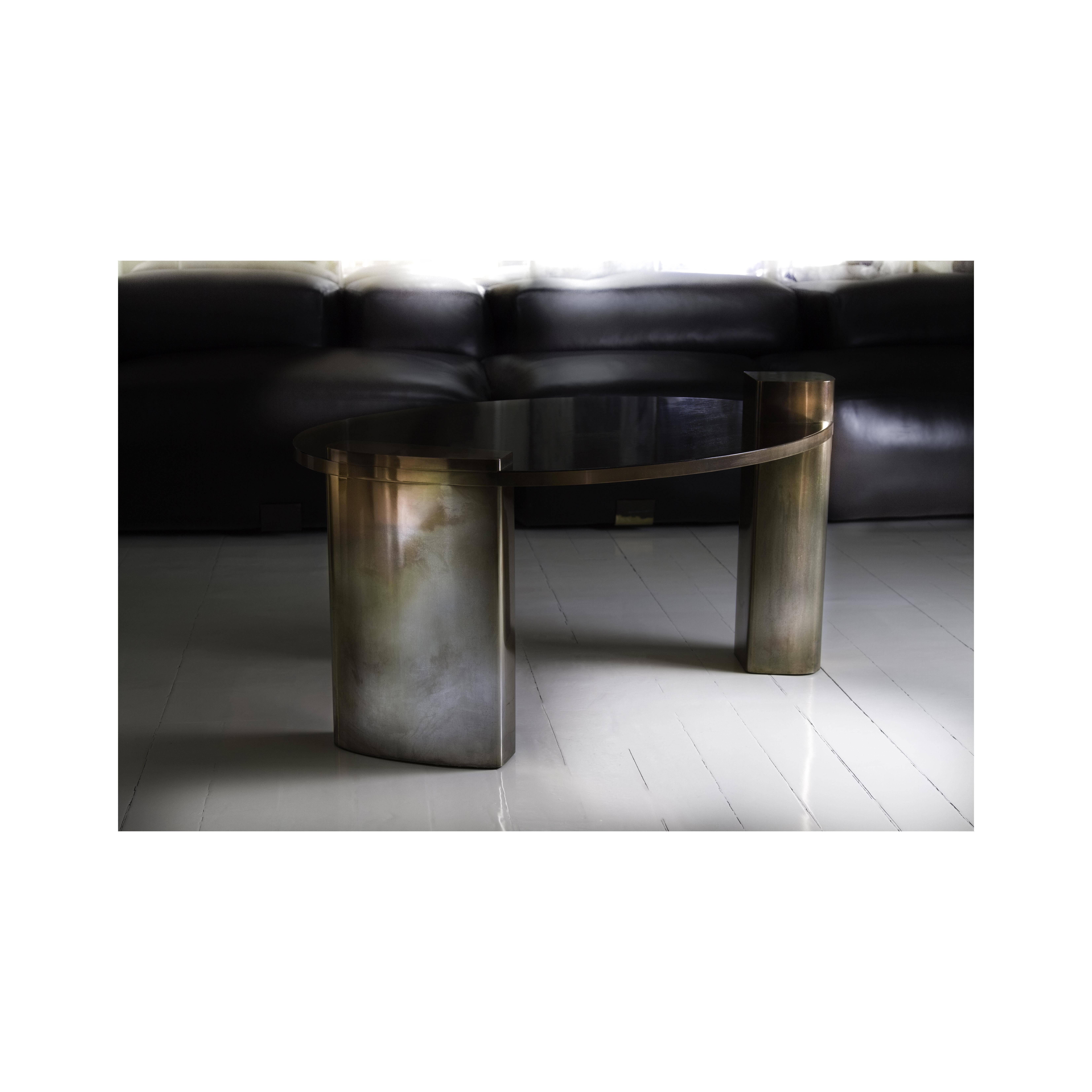 The rose toned hand patinated brass structure and rich mahogany wood veneer surface of the New Moon cocktail table provides a true combination of confidence and imperfection that resonates. This is nothing short of a true statement piece that all at