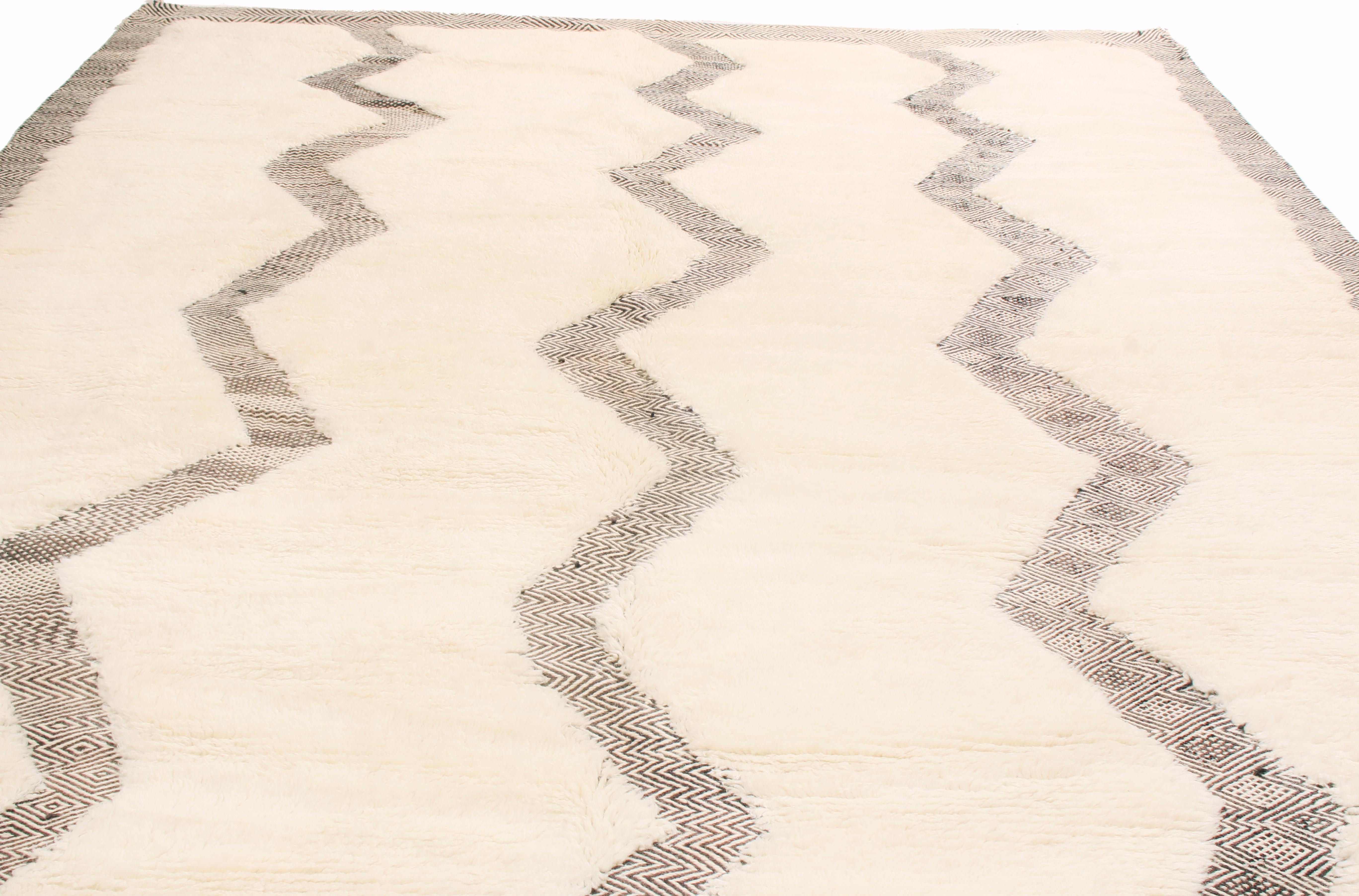 Originario del Marocco, questo nuovo tappeto geometrico marocchino di Rug & Kilim presenta caratteristiche distintive della recente produzione del paese d'origine. Mentre i vecchi telai marocchini erano troppo piccoli per ospitare tappeti di queste