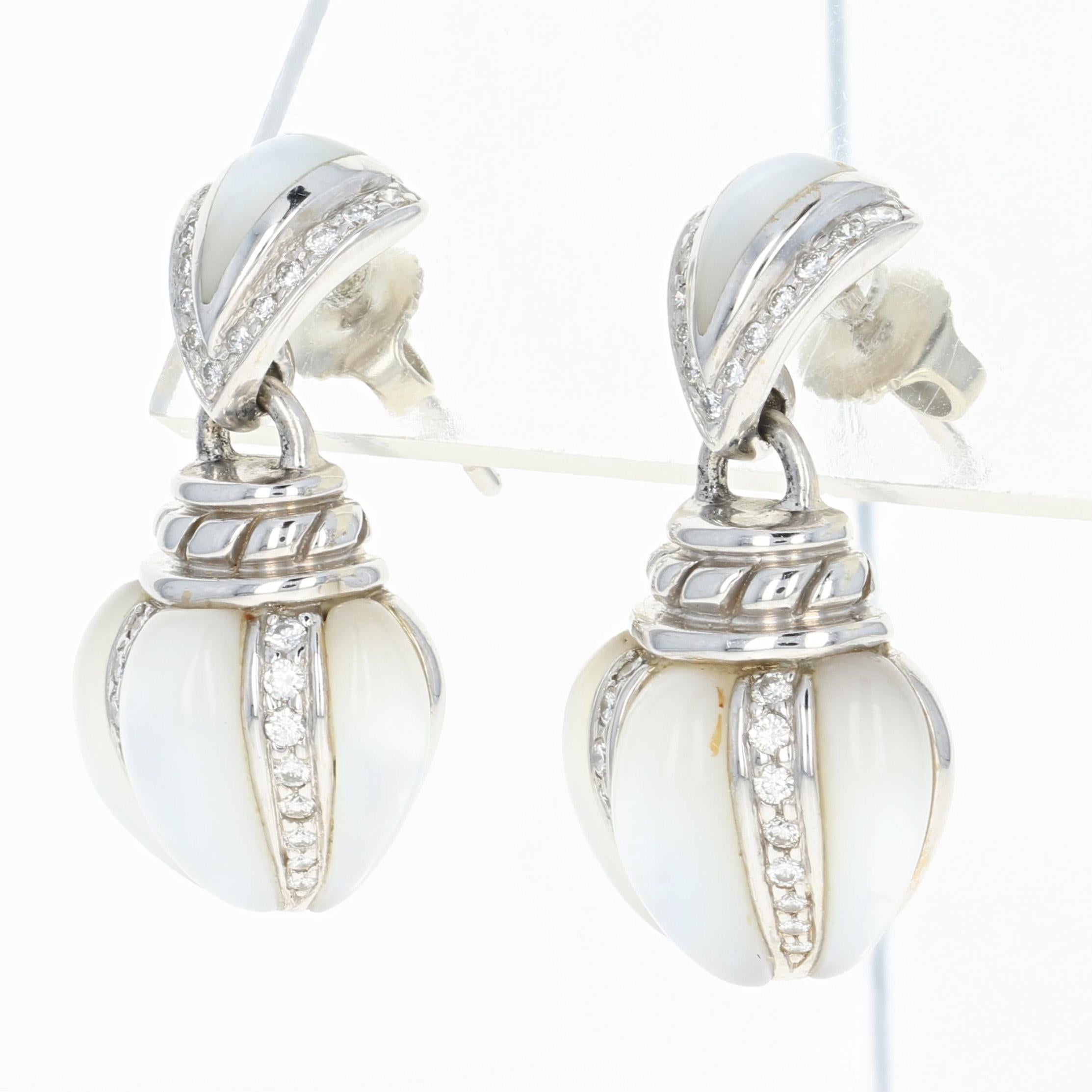 Regal Beauty! Crafted by Kabana in luxurious 18k white gold, this NEW pair of earrings are fashioned in a mesmerizing drop style which showcases luminous mother of pearl and icy white diamond accents. You are sure to be the belle of the ball wearing