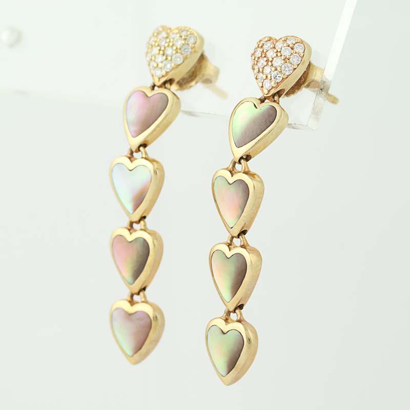 Give your sweetheart a token of your love and devotion she will always cherish! Composed of glowing 14k yellow gold, these NEW dangle-style earrings by Kabana showcase a cascading heart design adorned with light pink mother of pearl and clusters of