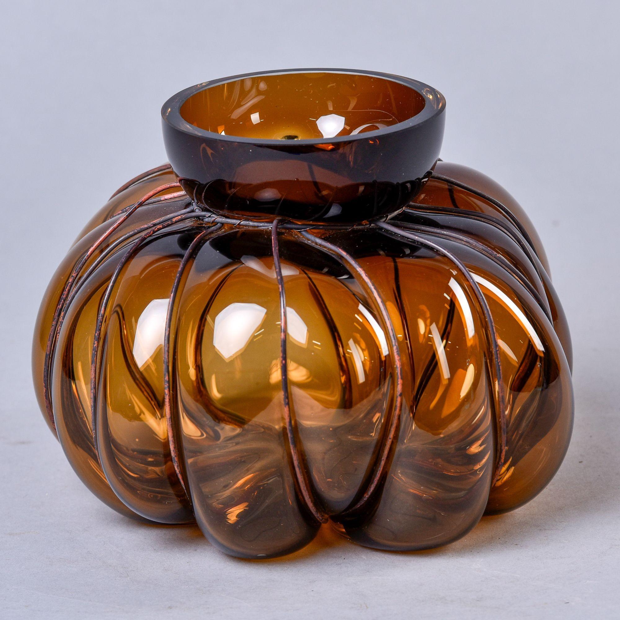 New mouth blown vase with metal surround by French glass artist Vanessa Mitrani. Glass has a rich amber tone and interesting, biomorphic gourd-like shape.