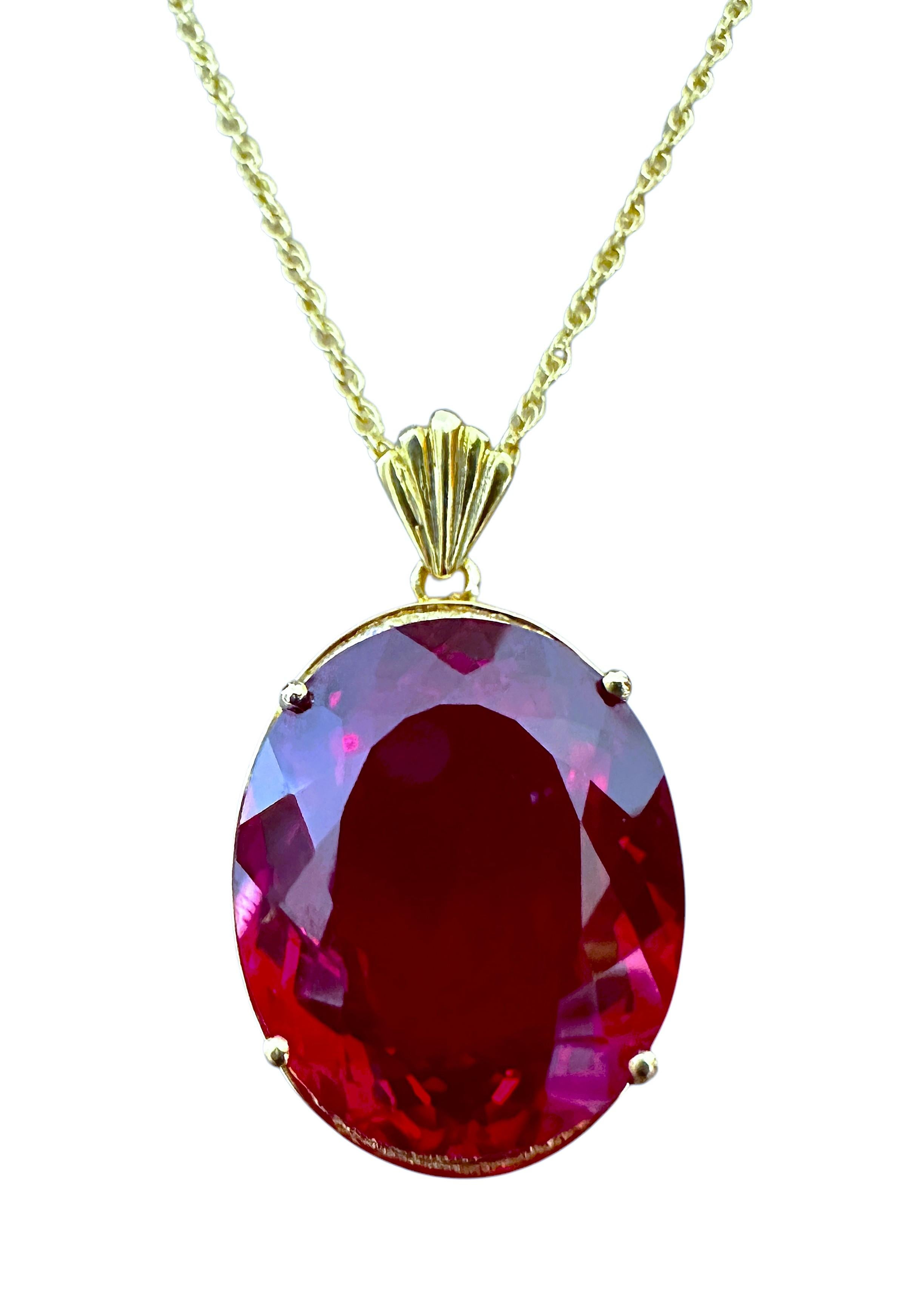 The stones are from Africa and is just exquisite. The main stone is a red sapphire and is 33.30 cts.  The stone is an oval cut  stone and measures 21 x 18 mm and is surrounded by diamond cut white sapphires and are placed in a beautiful yellow gold
