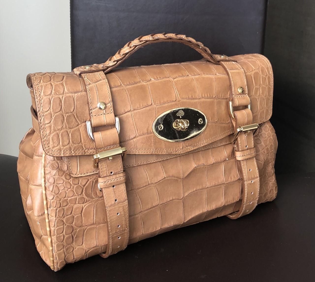 Never-worn Mulberry 'Alexa' medium brown crocodile print satchel bag, with gold hardware. This bag can be worn as a cross-body or a shoulder bag, or as a simple hand-bag. In excellent condition throughout (still with some plastics), the bag has
