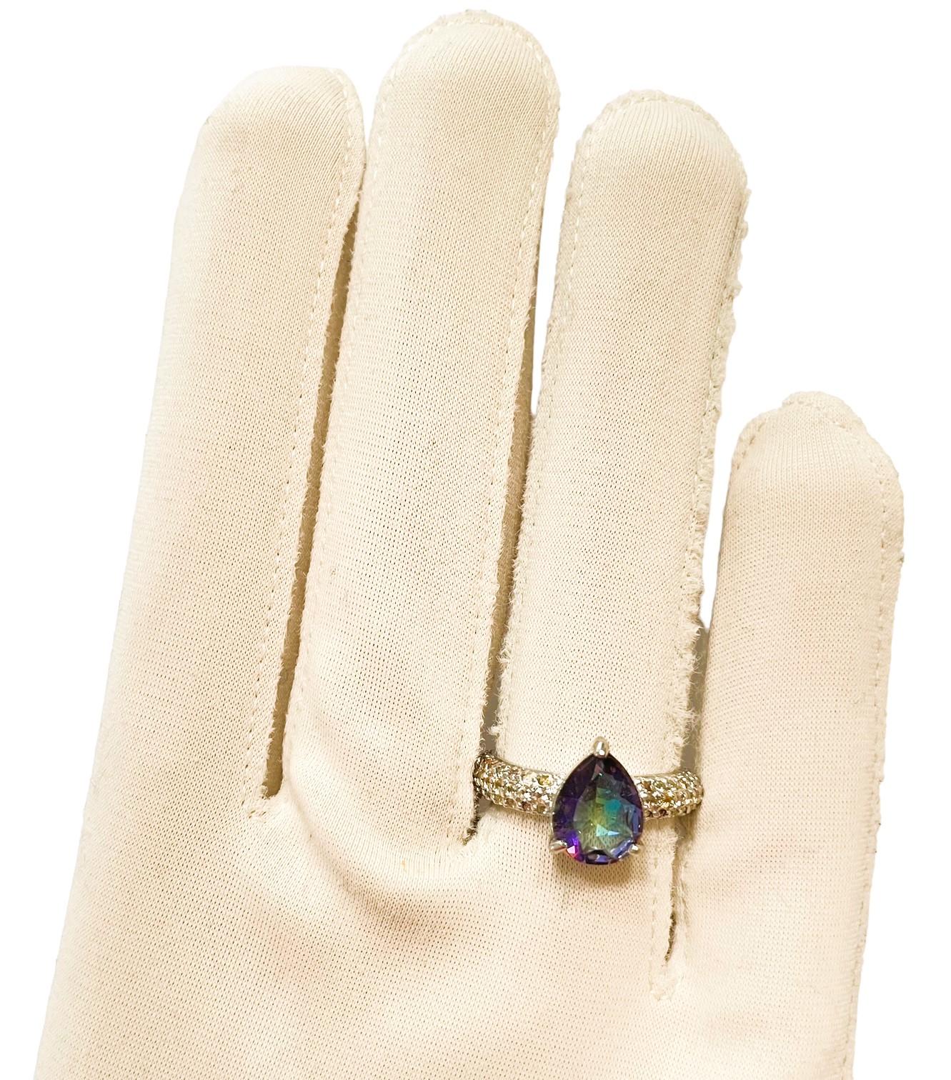 What a gorgeous ring!  It is a size 7 and white gold plated.  This beautiful stone turns so many colors.  It is an authentic natural stone so you can bid with confidence.  The stone is a pear cut stone.  It measures 10 x 8 mm.  It is flanked by