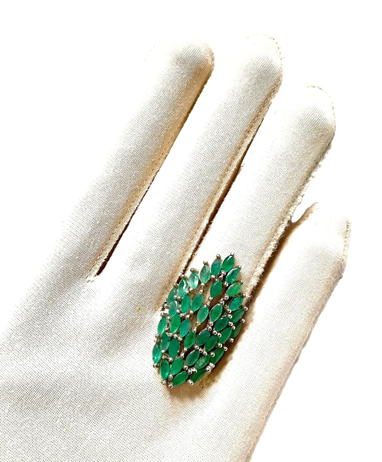 The ring is a size 7.5. The stone is natural and just a beautiful shade of green.  I believe I counted 36 Emeralds in this ring.  The stones are all approximately 5.4 x 2.5mm in size.  It is approximately 6.12 Cts in total.  It's just a beautiful