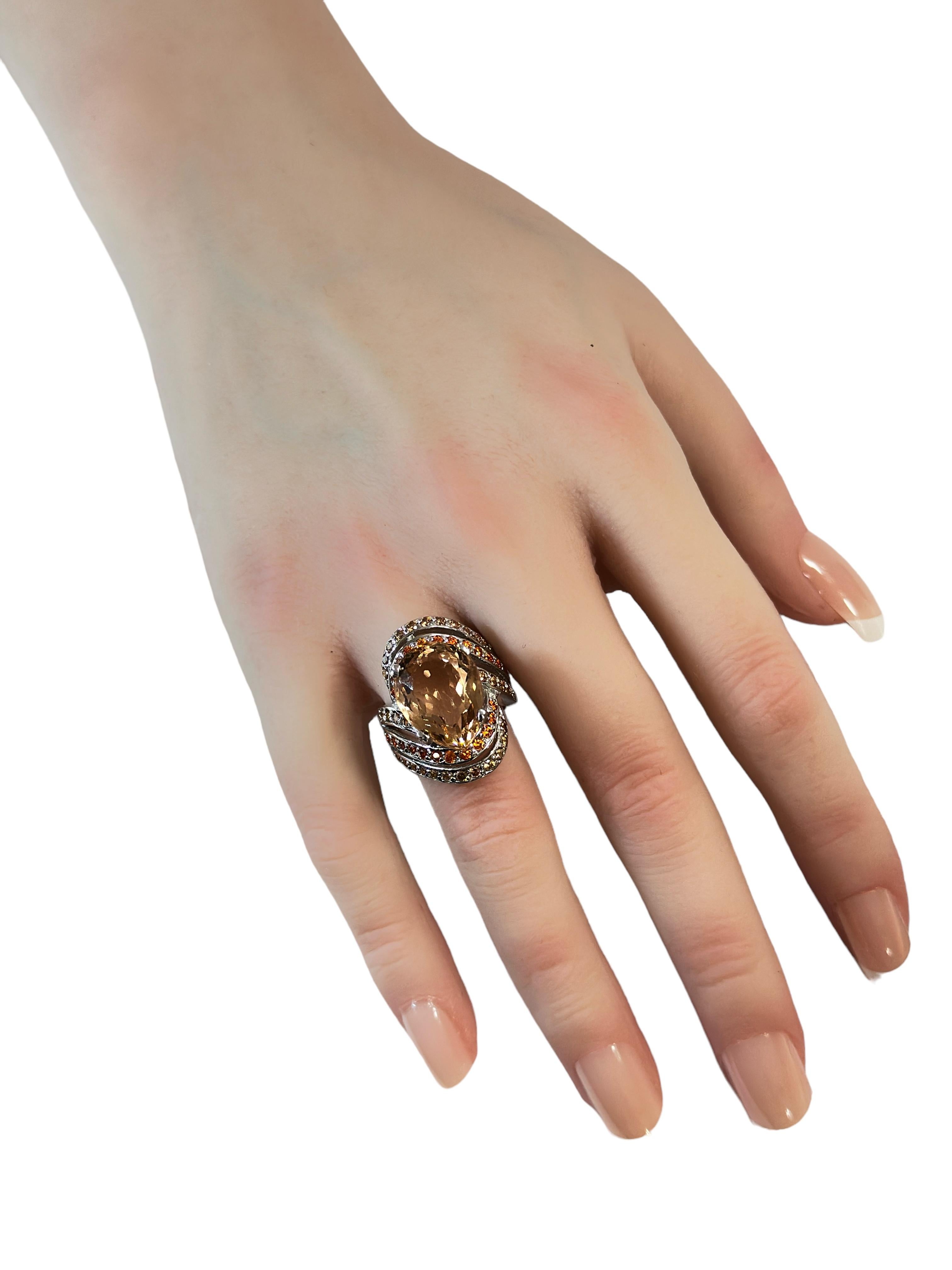 The cut of this stone and design of this ring is just phenomenal. The ring is a size 6.   The stone is from Africa and is just exquisite.  It is a very high quality stone.  It is an oval cut stone and is 8.6 Cts   The main stone is 16 x 12 mm and it