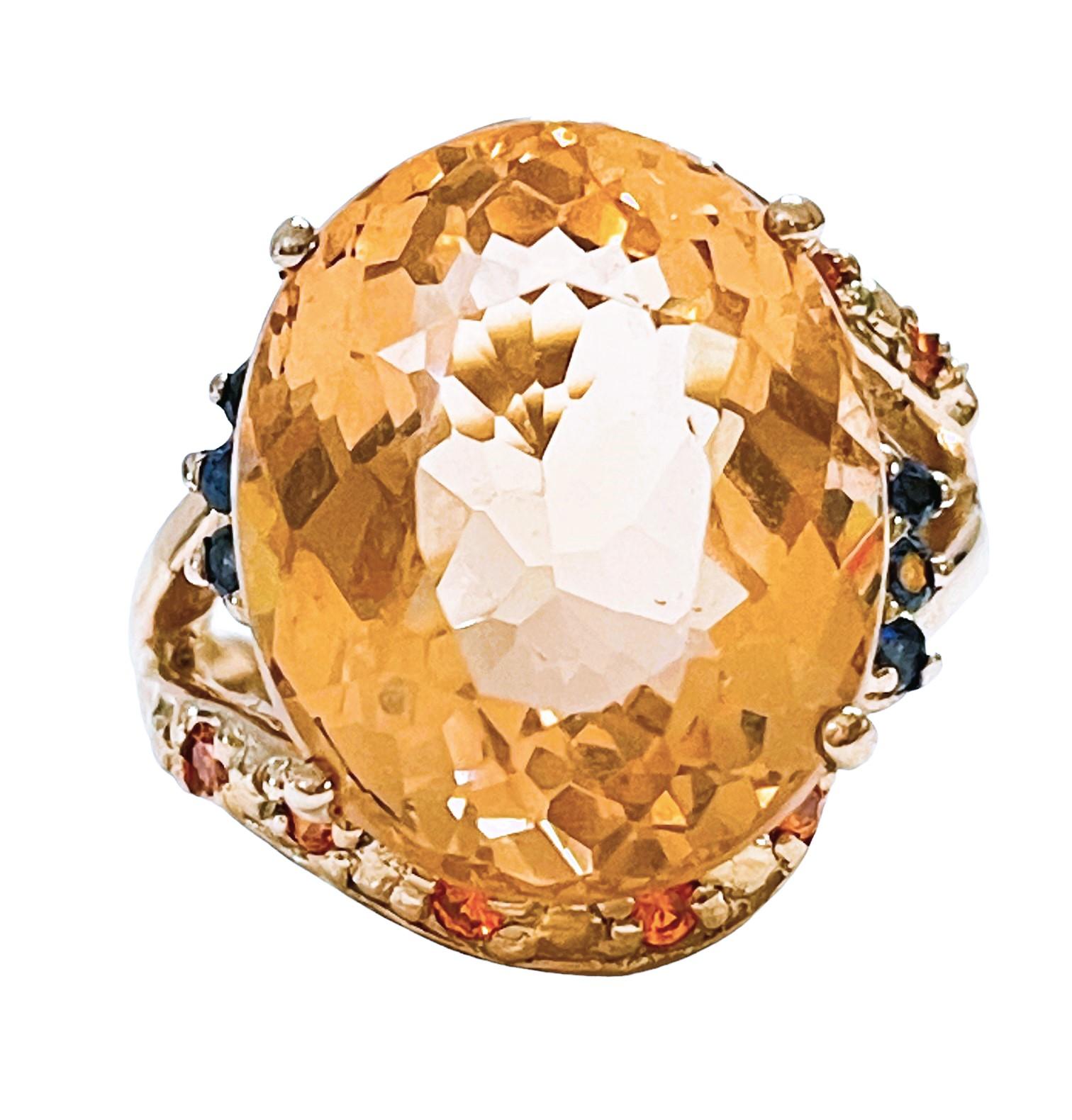What a gorgeous ring!    It is a size 6.5.   It was mined in Africa and is just exquisite.    A very high quality and rare stone. It is an oval cut stone and is 12.76 Cts.   The main stone is 17 x 14 mm and is surrounded by Diamond Cut Orange,