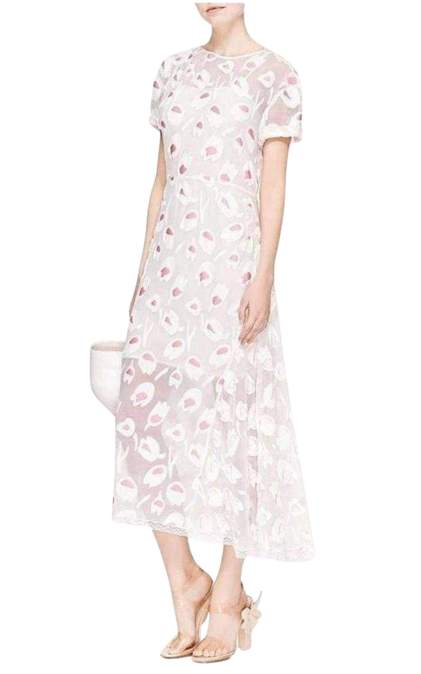 This dress is crafted in tactile, flocked silk chiffon with a charming floral pattern. 
A reversed panel accents one side of the airy skirt, and delicate lace trims the hem. 
Silk-covered buttons fasten the back, and a slim strap ties behind the