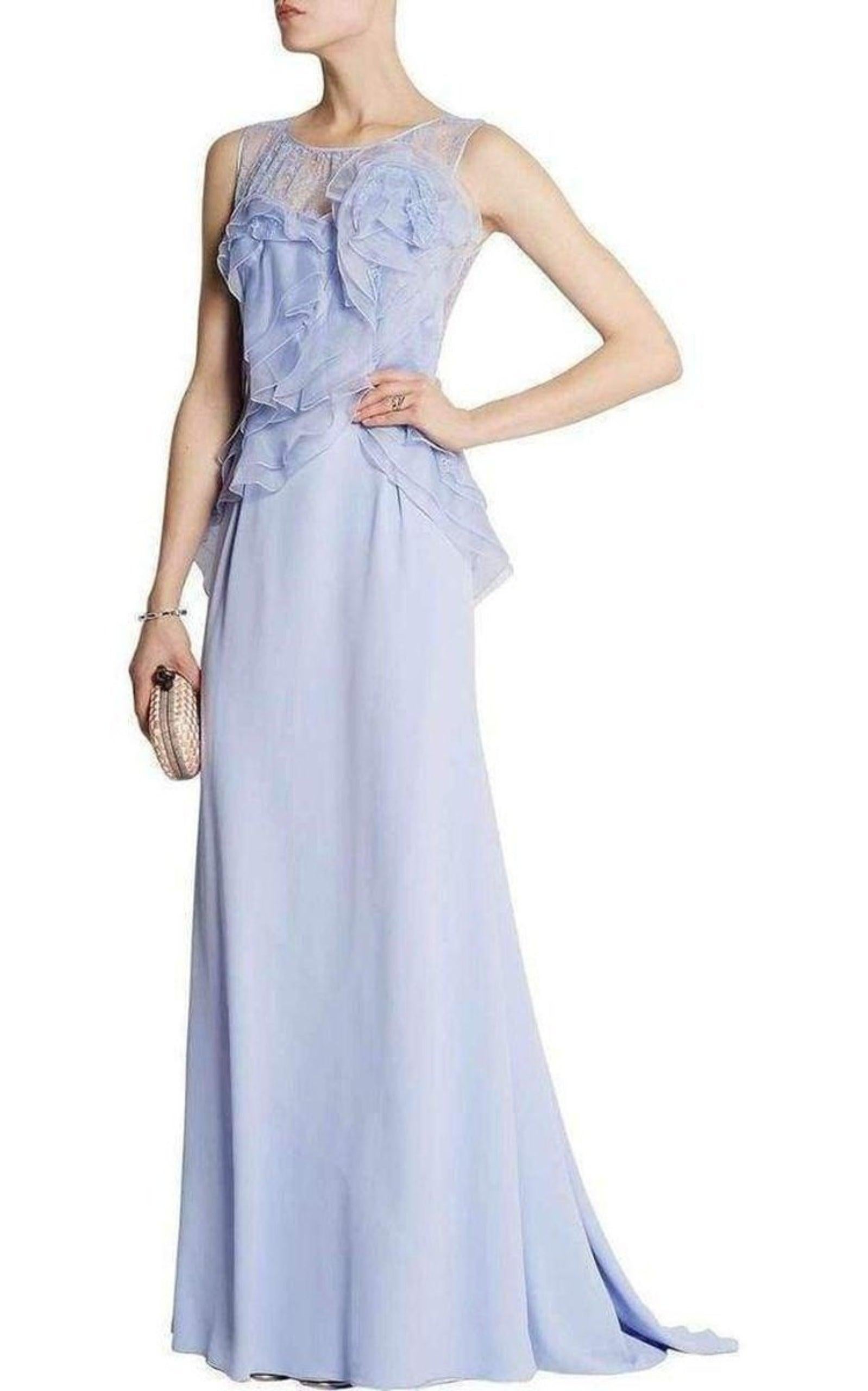 Nina Ricci's lavender silk crêpe sleeveless gown is flou tailored with layers of frothy ruffles running in a diagonal across the bodice.
Floor-length gown
Lavender lace back and lavender lace gathered front neckline
Jewel neckline
Slight train at