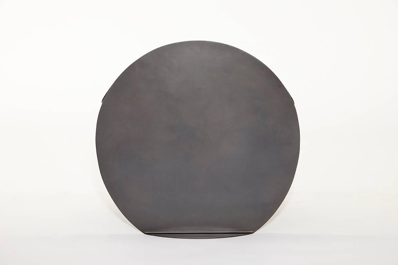 Introducing the O Stool in blackened stainless steel for indoor or outdoor use. Also available with a polyurethane finish, and in custom colors.  It takes the circular shape to its limits, unfolding and folding again to create a fluid softness in