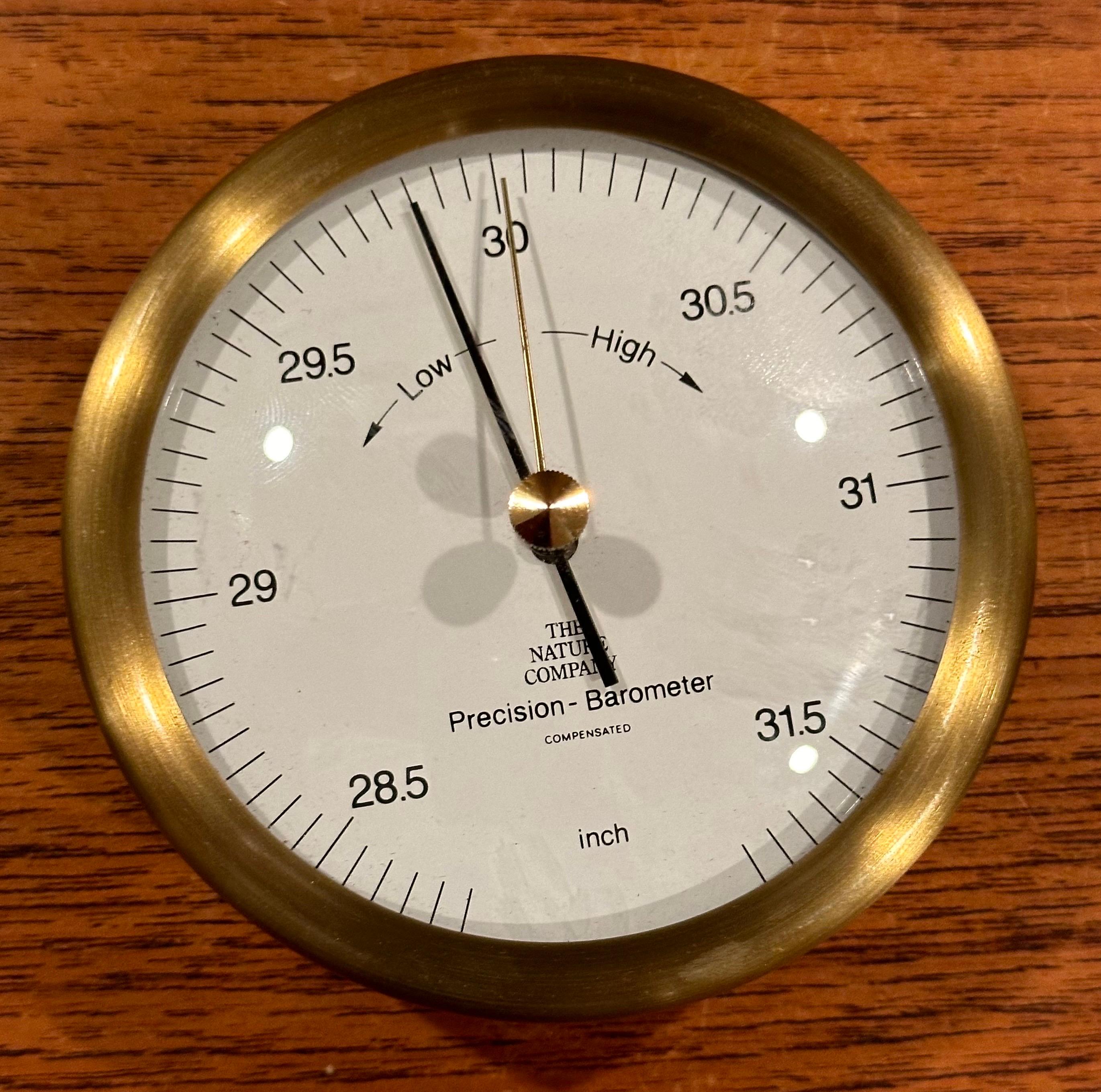 New / old stock precision wall barometer in brass by The Nature Company, circa 1990s.  The piece is in excellent working condition with original box and measures 4.25