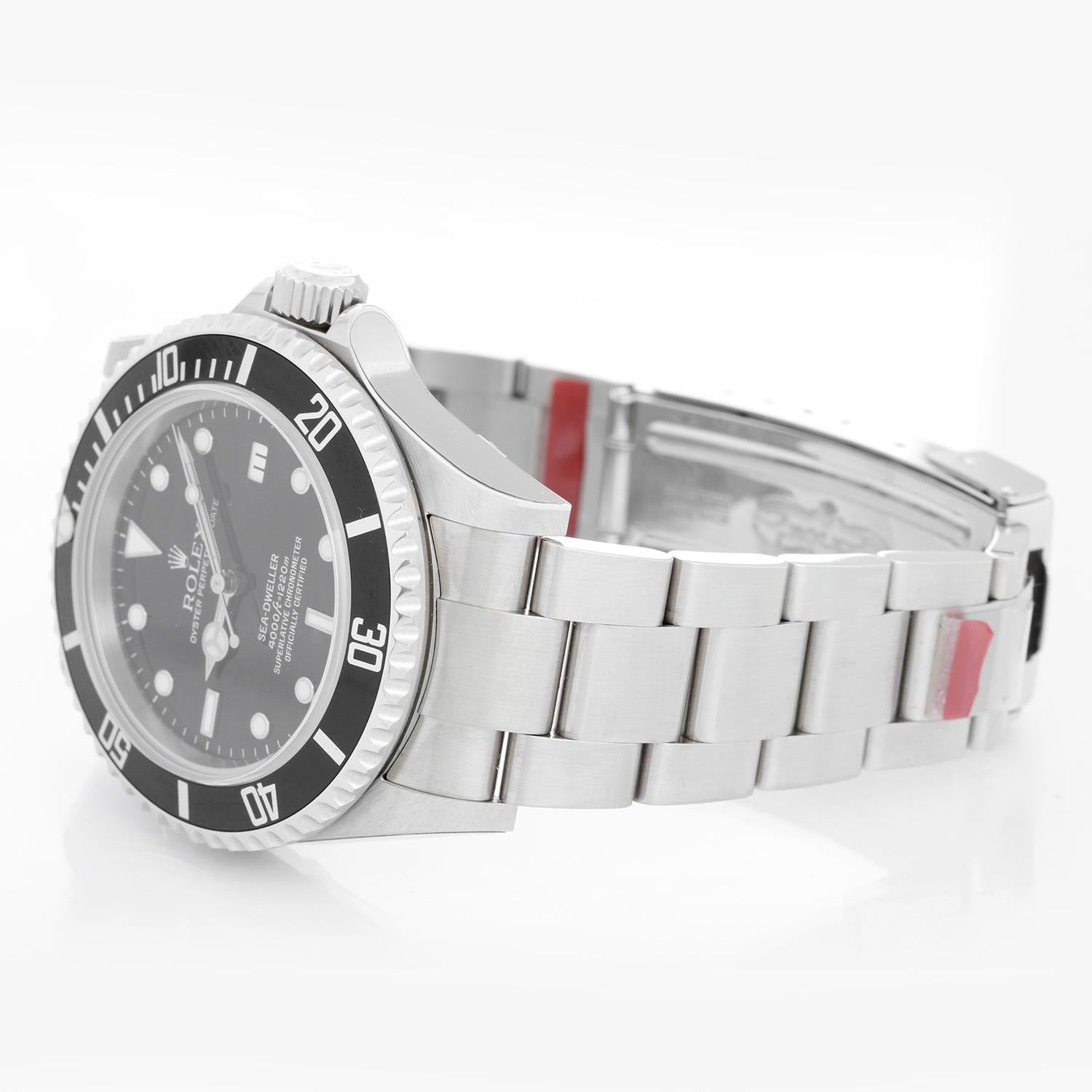 New Old Stock Rolex Sea Dweller Stainless Steel Men's Divers Watch 16600 - Automatic winding, 31 jewels, Quickset, sapphire crystal. Stainless steel case with rotating bezel and helium escape valve (40mm diameter). Black dial with luminous markers.