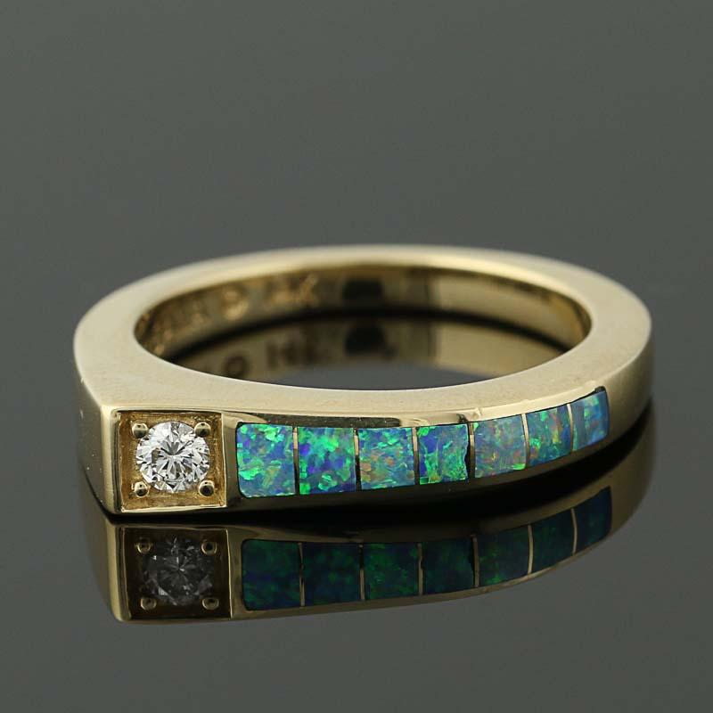 Give your wardrobe a touch of designer glamour with this gorgeous ring! Fashioned by Kabana in 14k yellow gold, this chic NEW piece features a modernist face accentuated with a bead-set diamond. Inlaid opals adorn the face and one side of the angled