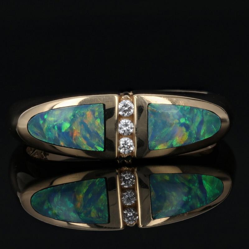 Elegant and stylish, this gorgeous Kabana ring makes a great gift for any occasion! This chic NEW piece is fashioned in classic 14k yellow gold and features a squared face adorned in the center with a row of diamonds. Inlaid opals with stunning