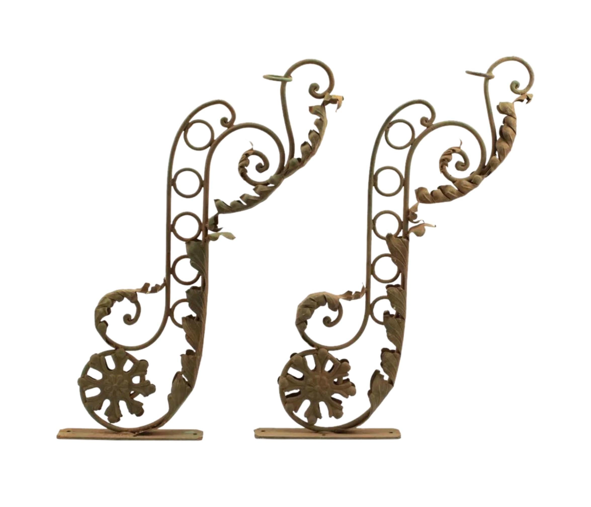 Hand forged pair of wrought iron foliate scroll sign brackets made in New Orleans. These were signage for a French Quarter Hotel. These are beautiful objects as is - or could be made into grand electrified or candle sconces.