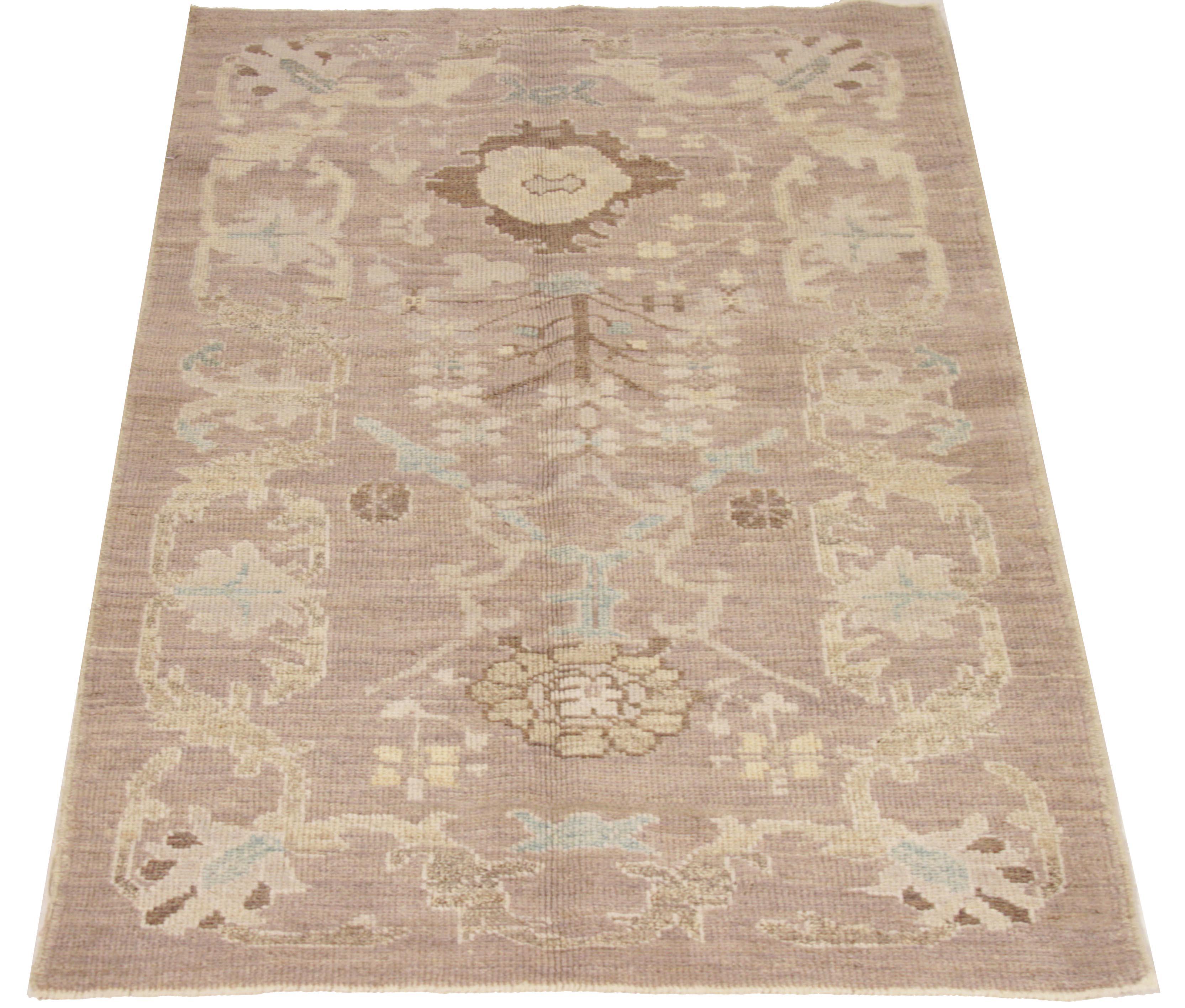 Handcrafted Persian rug made from the finest sheep’s wool and colored with 100% organic vegetable dyes that are safe for humans and pets. It shows a traditional Oushak design featuring a brown field with blue and beige floral patterns. It’s an