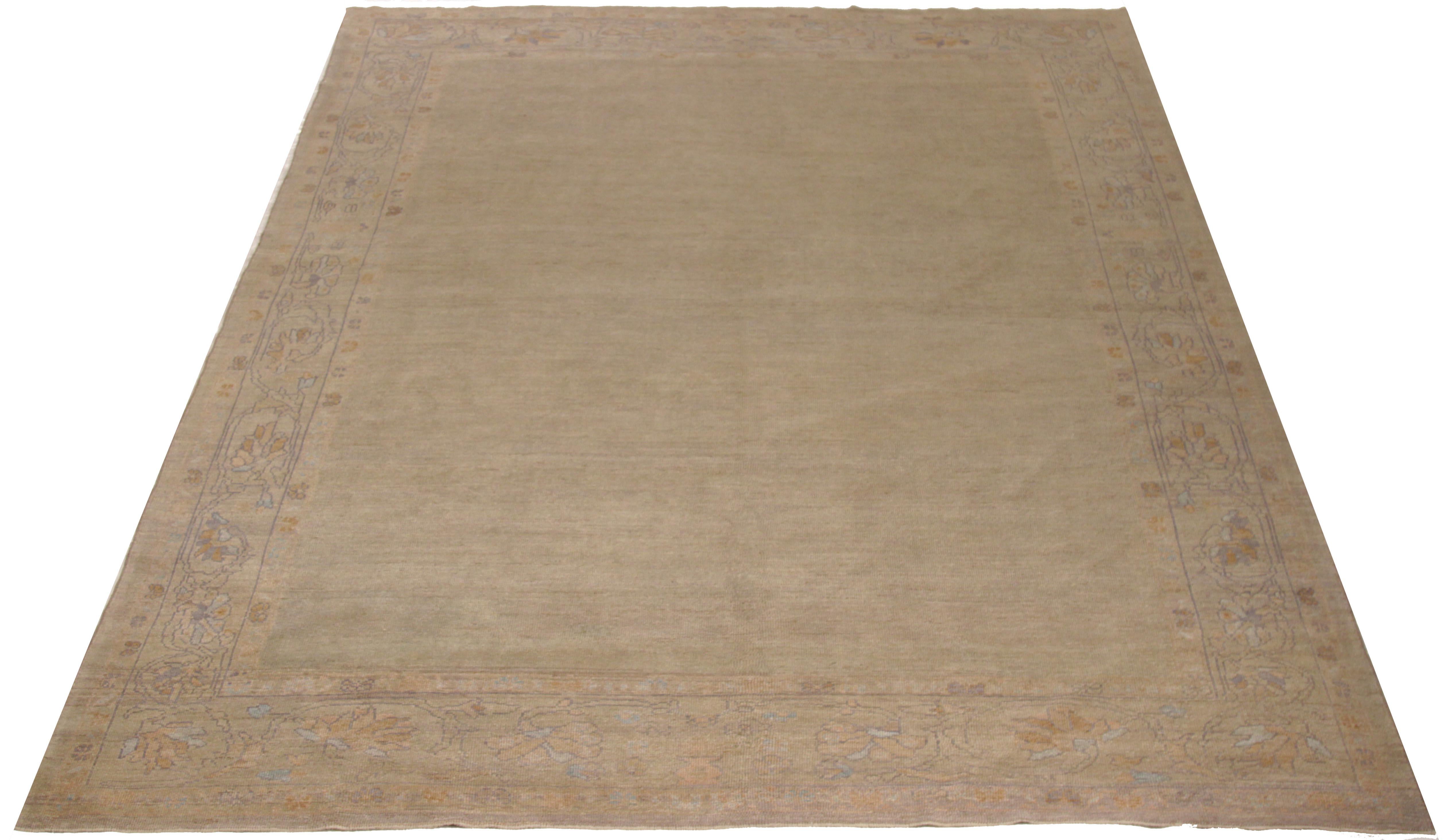 Persian rug handwoven from the finest sheep’s wool and colored with all-natural vegetable dyes that are safe for humans and pets. It exhibits a traditional Oushak design featuring a brown and beige mix field enclosed by an intricate flower-patterned