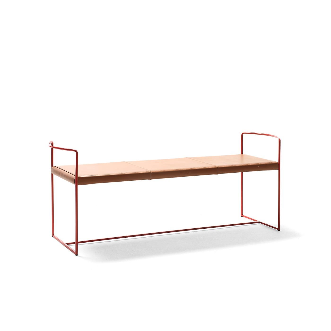As suggested by its name, this graceful bench stands out for the unparalleled lightness of its minimalist frame in red-lacquered steel. Luxe, brown cowhide with exposed stitching covers the seat, which is framed by two delicate armrests with a