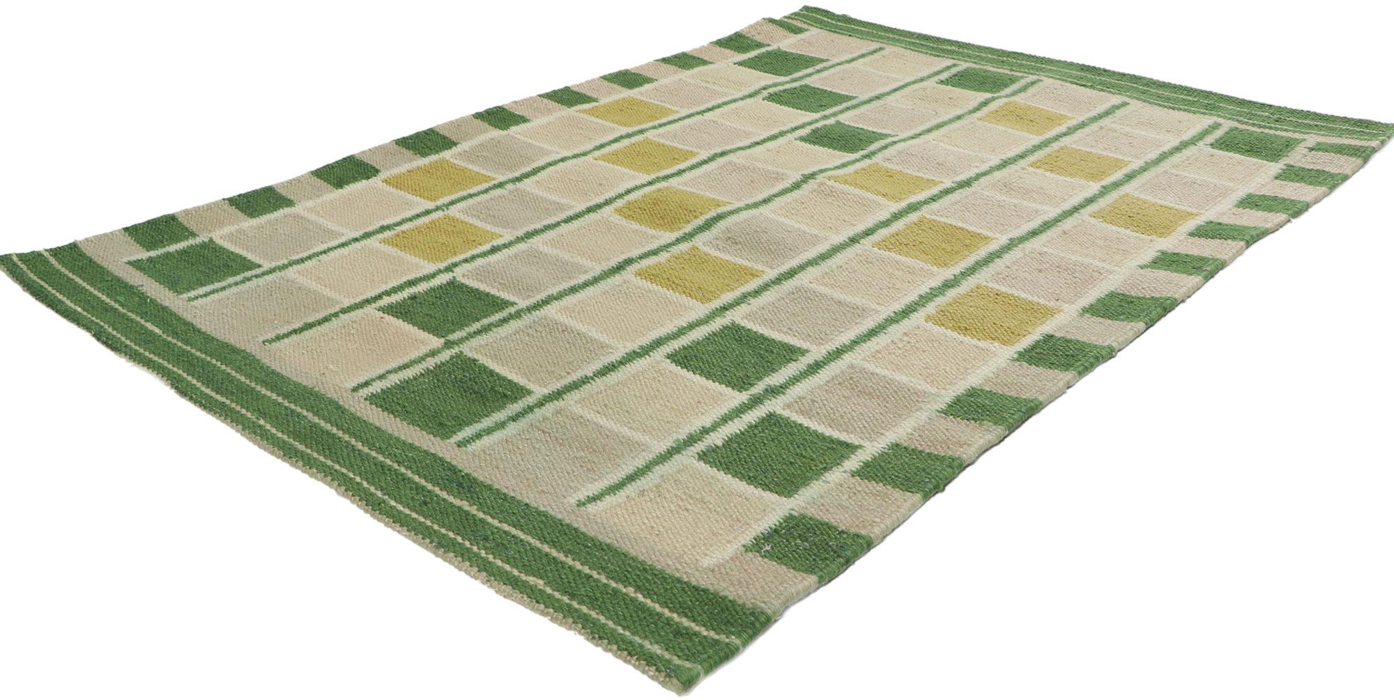With its geometric design and earthy colorway, this hand-woven wool Swedish inspired Kilim rug beautifully embodies the simplicity of Scandinavian modern style. The abrashed field features an all-over checkerboard pattern comprised of squares and