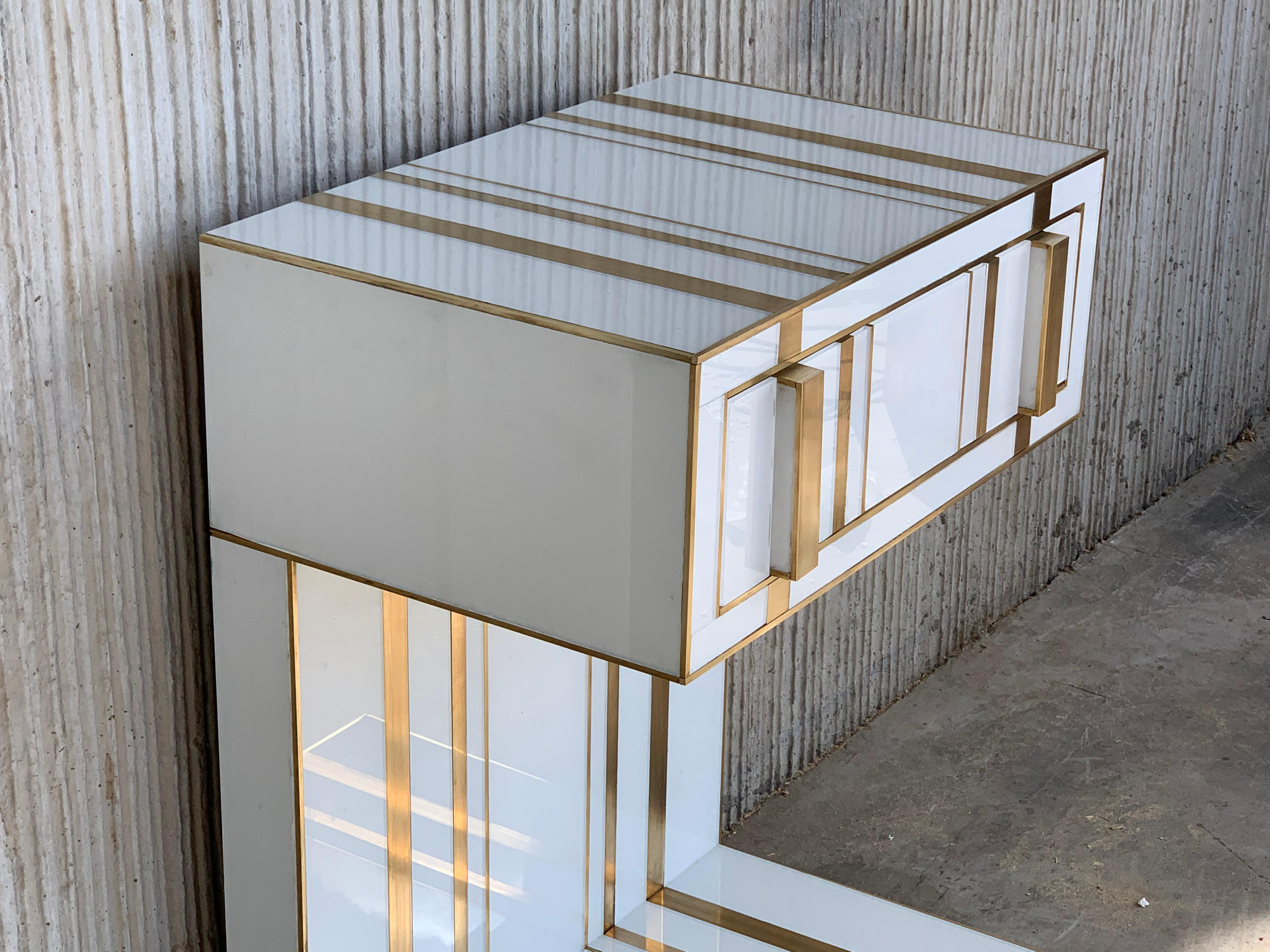 New pair of white glass and brass nightstands with one-drawer, mirrored details in drawers.
Soft push system opening with brake in drawers.
Two glass and brass handles.


We can make it in custom size or custom color upon request.