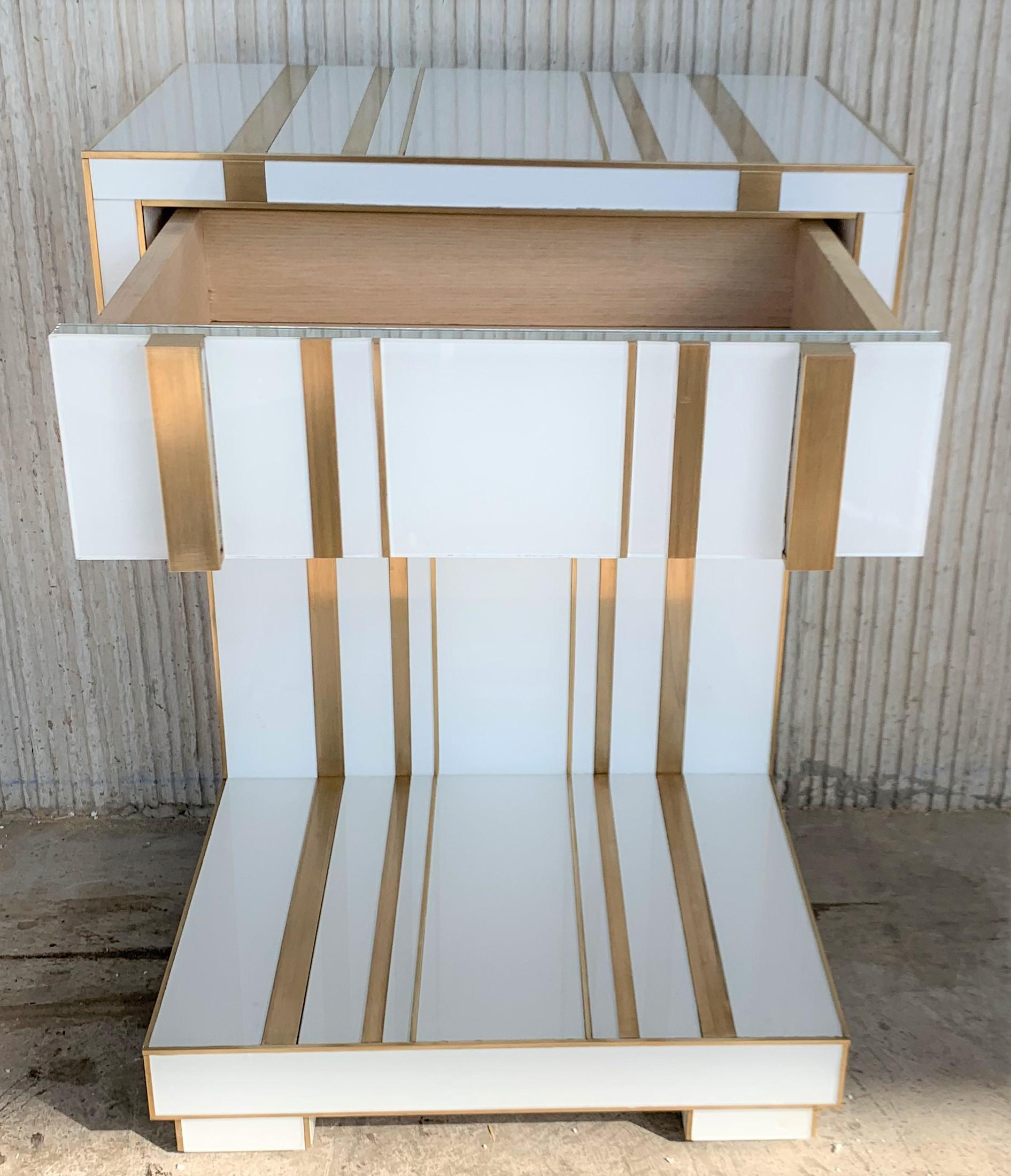 New pair of white glass and brass nightstands with one-drawer, mirrored details in drawers.
Soft push system opening with brake in drawers.
Two glass and brass handles


We can make it in custom size or custom color upon request.