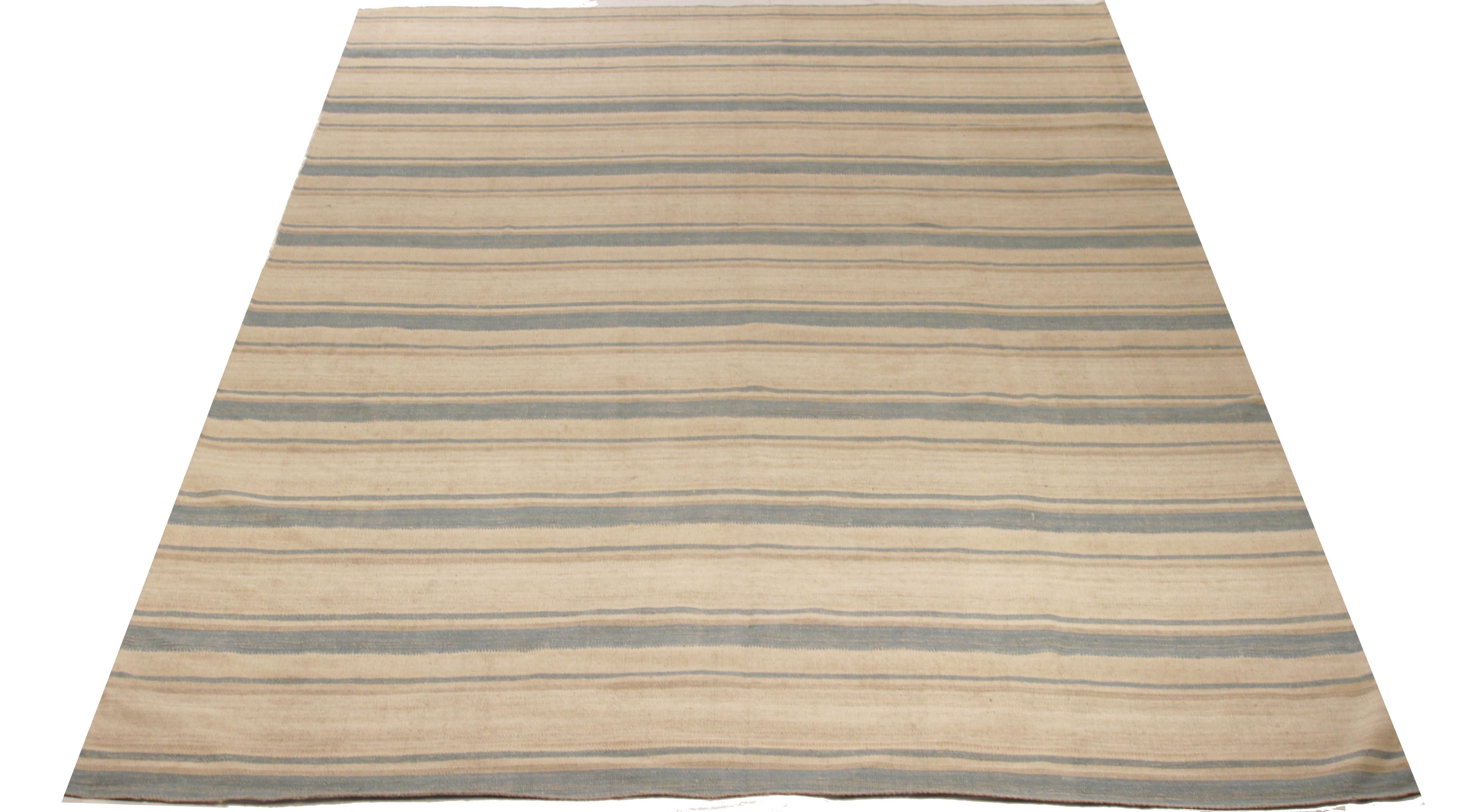 A new production Persian rug handwoven from the finest sheep’s wool and colored with all-natural vegetable dyes that are safe for humans and pets. It’s a traditional Kilim flat-weave design featuring a lovely ivory field with gray and beige stripes.