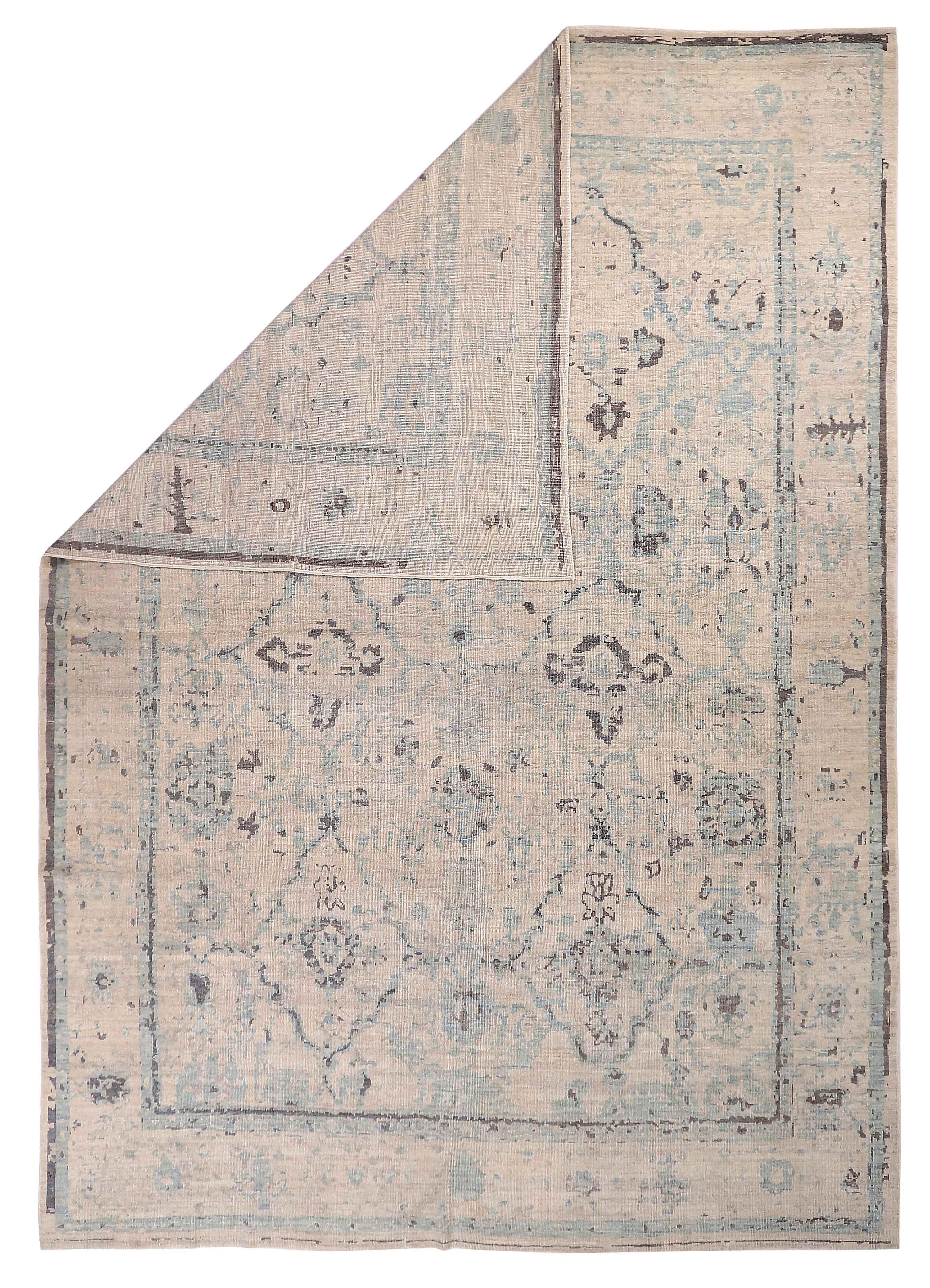 New Persian rug made of handwoven sheep’s wool of the finest quality. It’s colored with organic vegetable dyes that are certified safe for humans and pets alike. It features blue and gray floral details all-over associated with Oushak weaving from