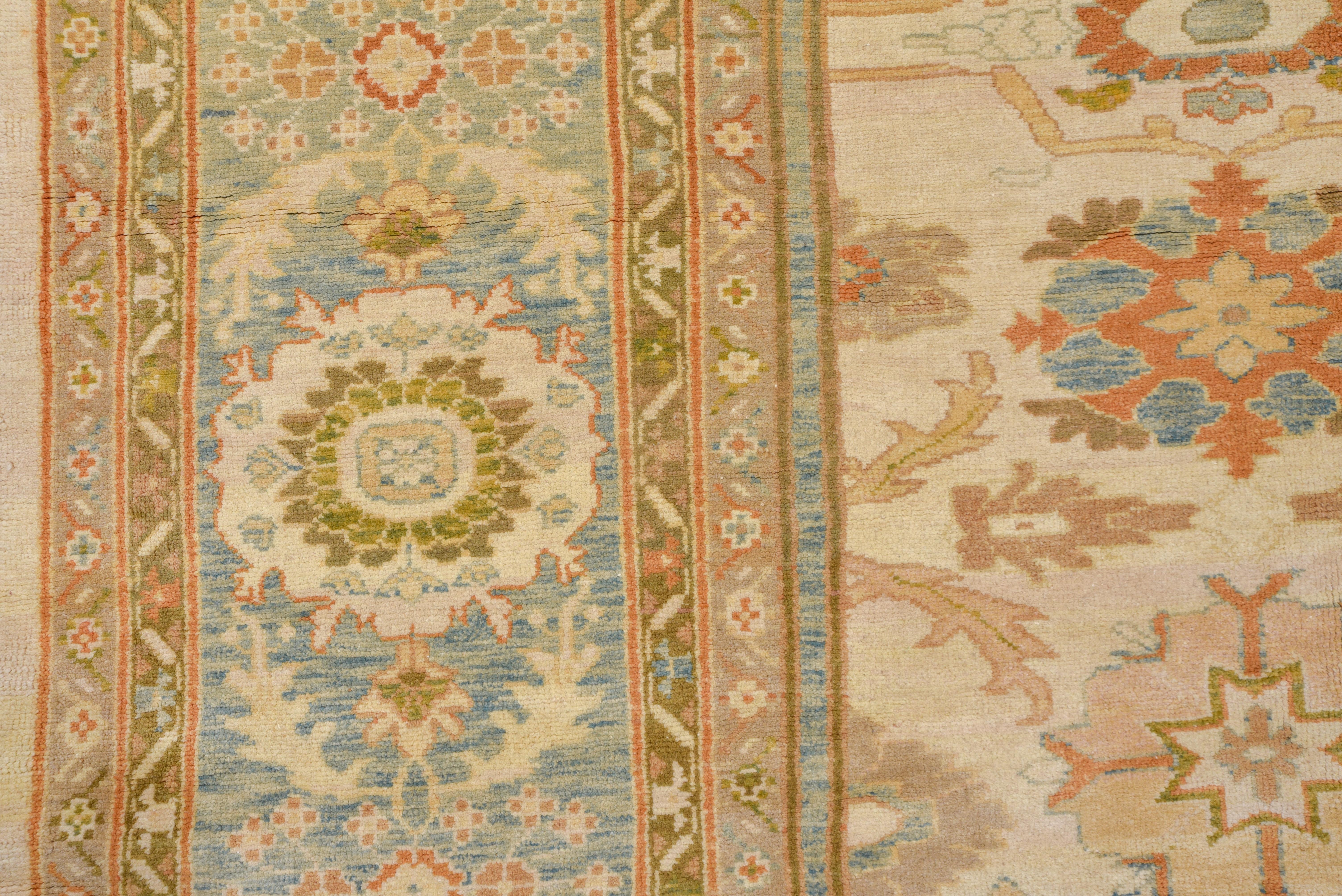 This as new Sultanabad-style carpet shows a cream field supporting a repeating, allover pattern of boteh-petal rosettes, medallions centering thin crosses and a number of other motives familiar from antique carpets. The very pale blue border rust