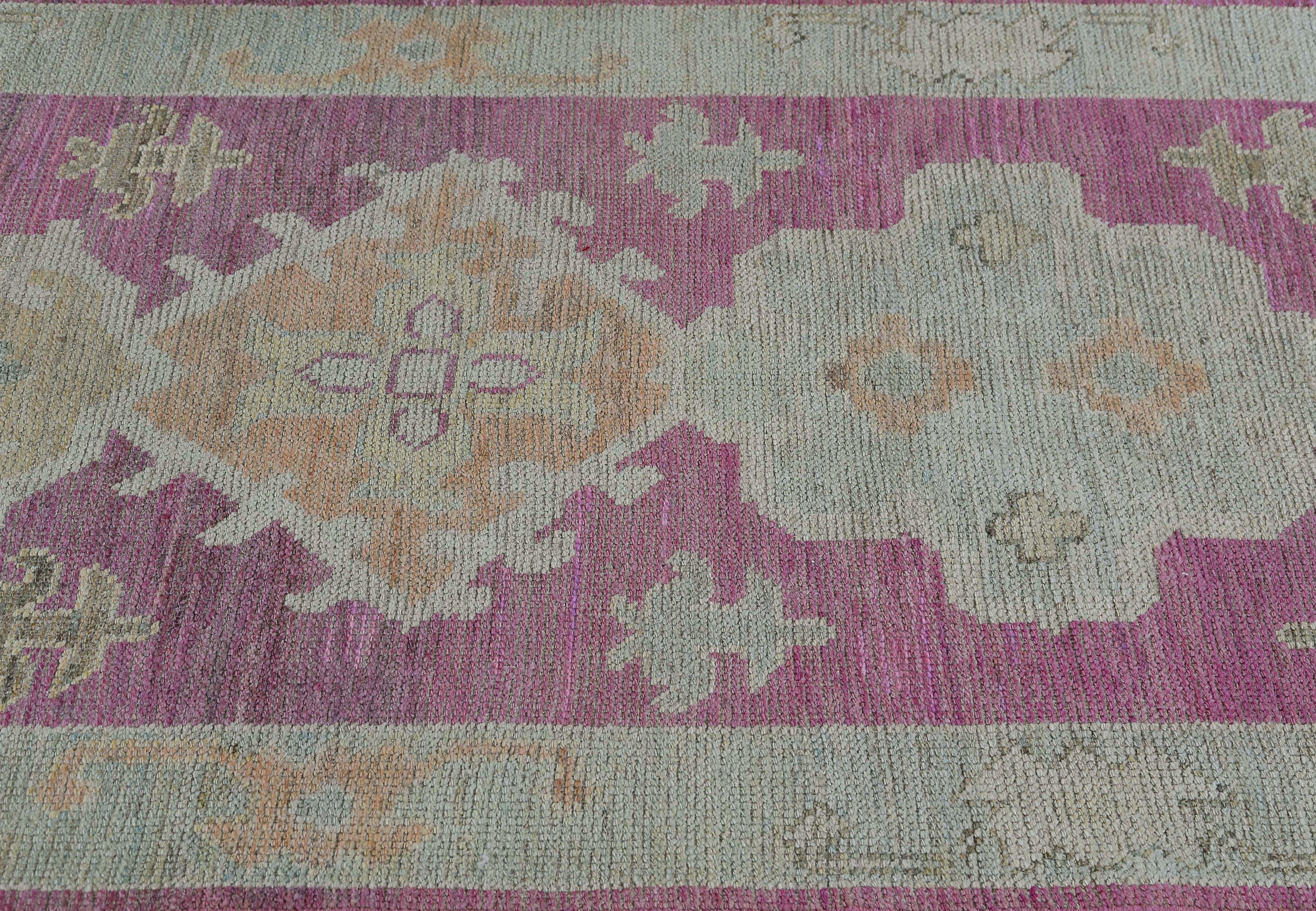 Introducing the exquisite Turkish oushak runner, a stunning piece of art that will add a pop of color and elegance to any hallway or entryway in your home. Measuring at 3'3'' x 9'9'', this runner's elongated shape and pink/purple foundation make it