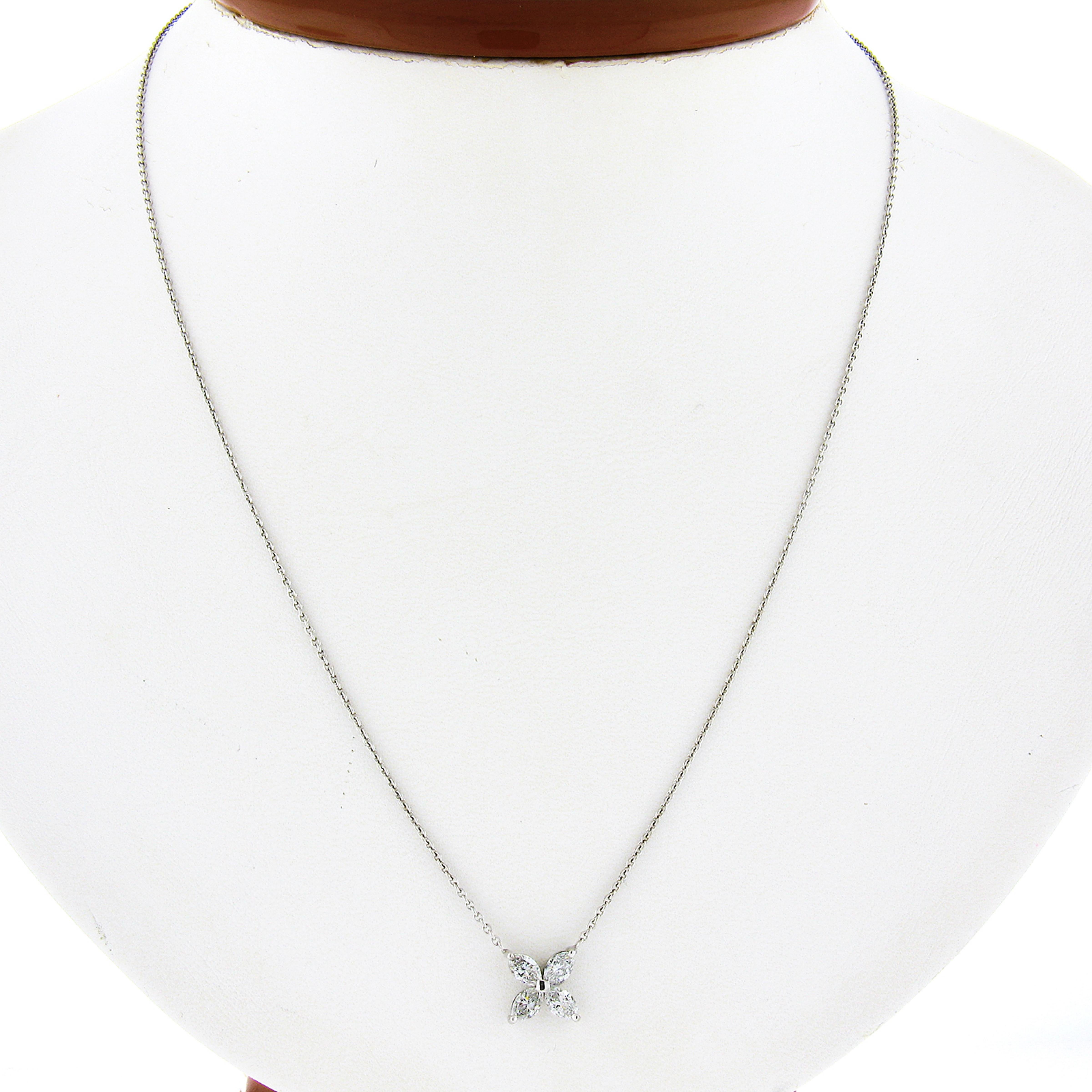 This gorgeous pendant necklace is newly crafted in solid platinum, and features a lovely flower-shaped pendant that consists of 4 marquise cut diamonds. The fiery diamonds are perfectly prong set on an open basket setting, and total 0.56 carats in