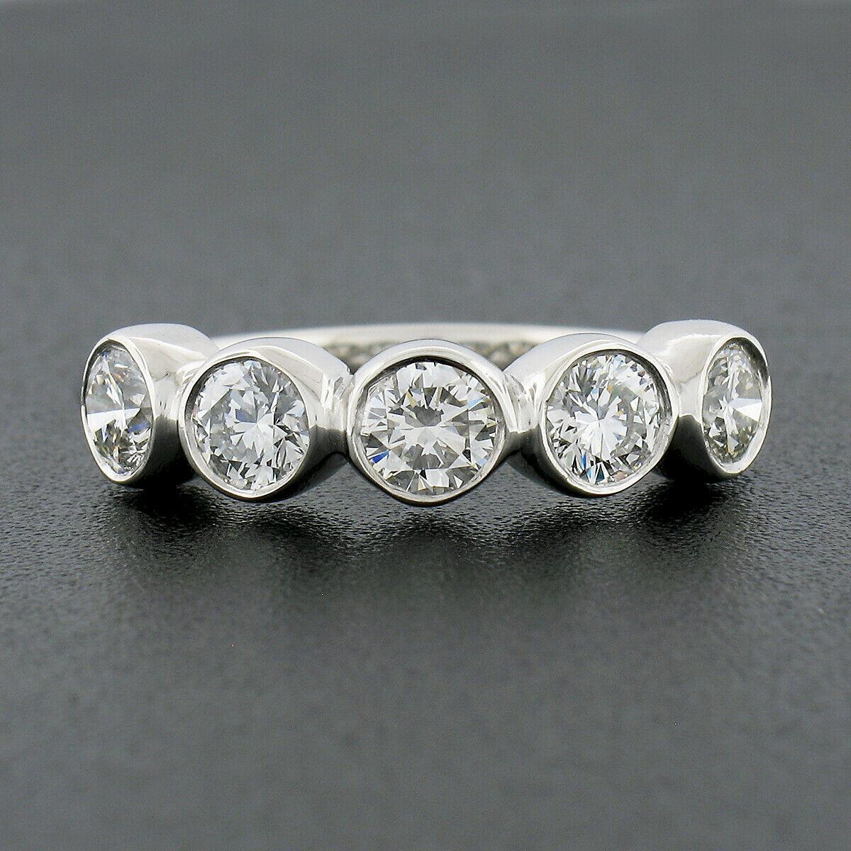 This magnificent diamond band ring was newly crafted from solid platinum and features 5 round brilliant cut diamonds neatly bezel set across its top. Each of these fiery diamond shows a very nice large size, totaling exactly 1.36 carats in weight,