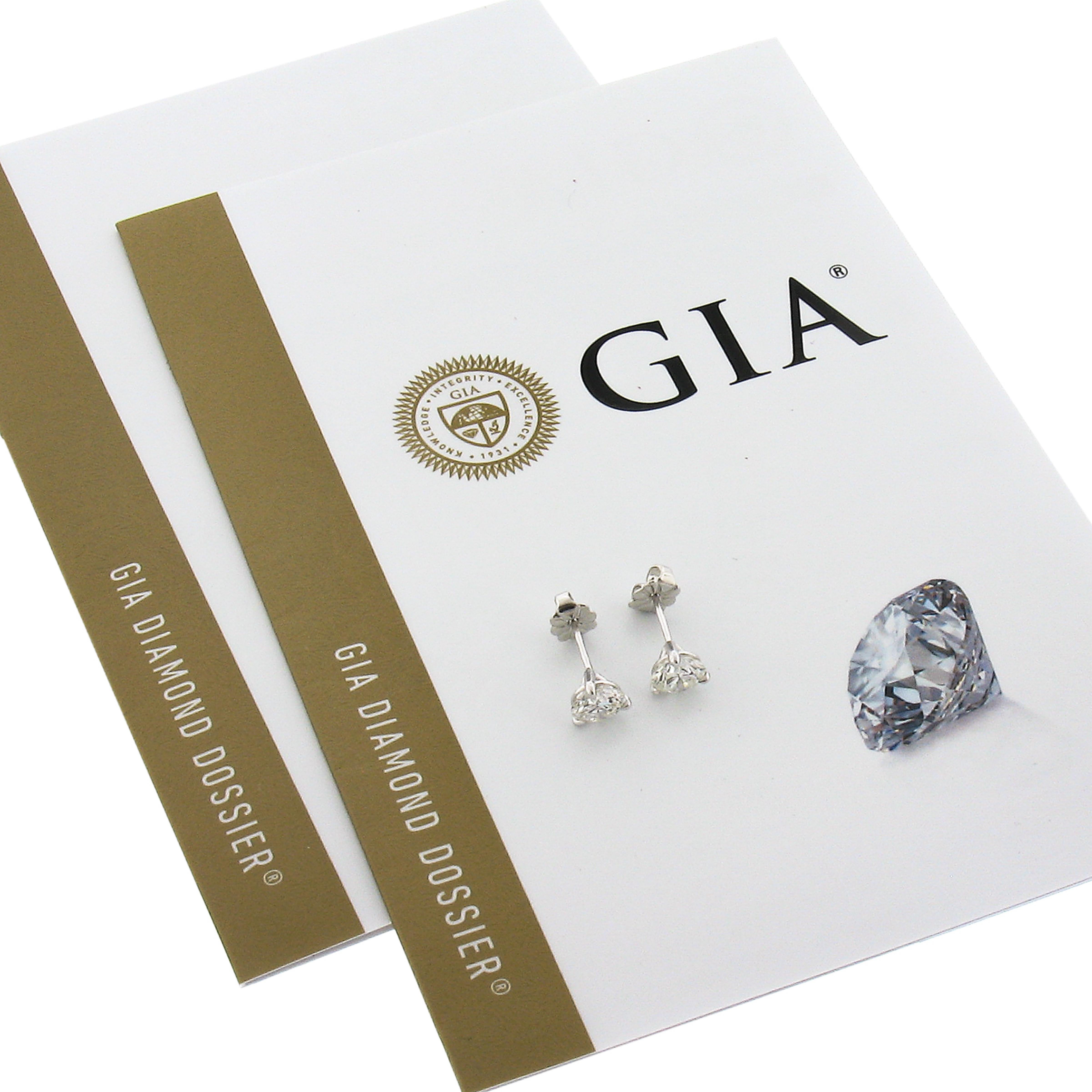 This classic pair of diamond stud earrings is newly crafted in solid platinum and features two gorgeous round brilliant cut diamonds that are both GIA certified. These diamonds weigh 0.76 each and are near colorless and very clean stones with (G/H