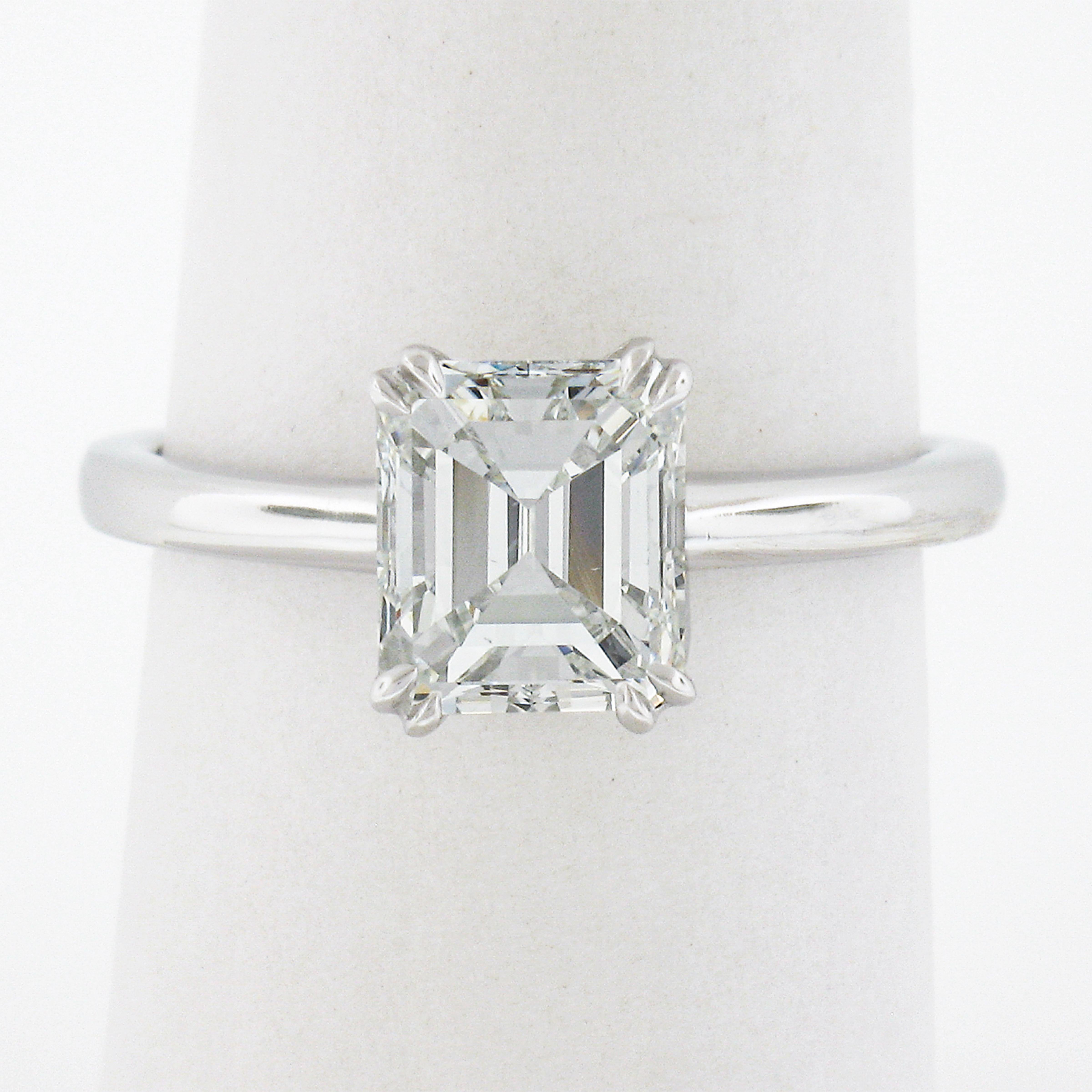 This classic and simply gorgeous solitaire engagement ring is newly crafted in solid platinum and features a very fine quality old emerald cut diamond neatly set at its center. This stunning, GIA certified, solitaire weighs exactly 1.88 carats and