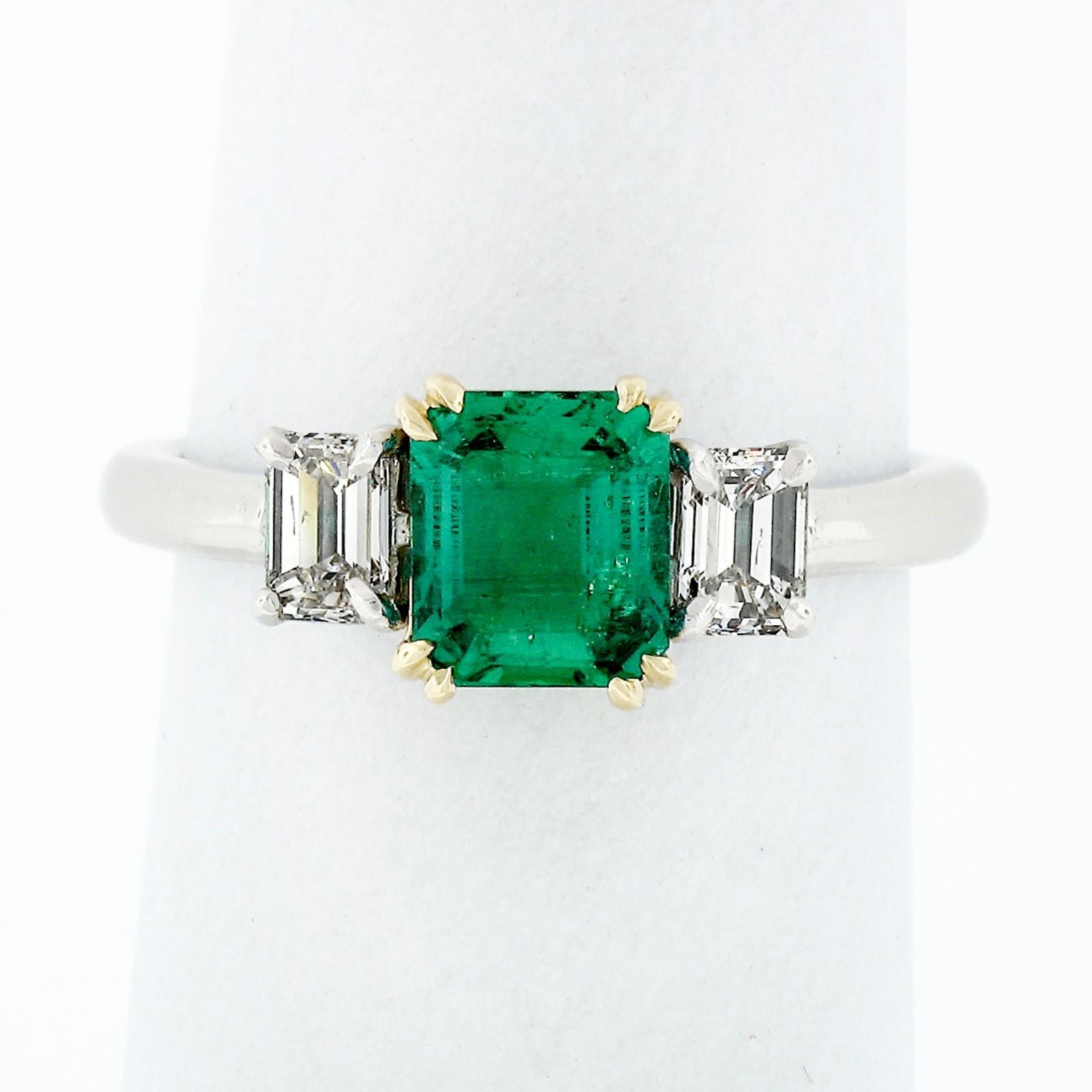 This stunning, GIA certified, Colombian emerald and diamond engagement ring is crafted in in solid platinum. The ring features a breathtaking, natural, octagonal step cut emerald stone that displays the finest and most desirable CLEAN green color.