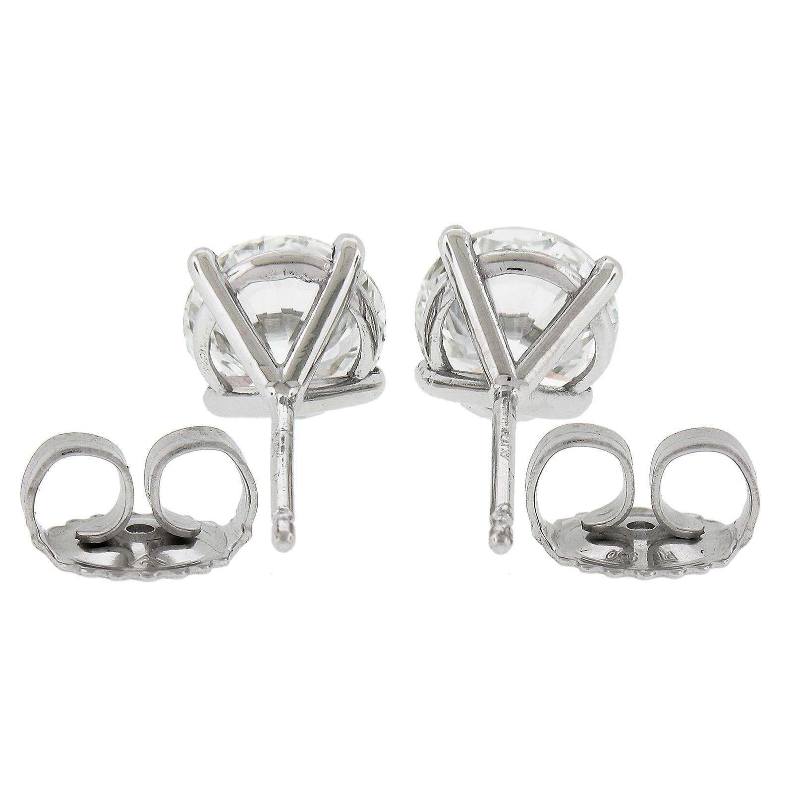 This classic and elegant pair of diamond stud earrings features two very well cut round brilliant and fiery, GIA graded diamonds that are neatly claw prong set in the stylish martini settings. These very fine quality diamonds total exactly 2.22