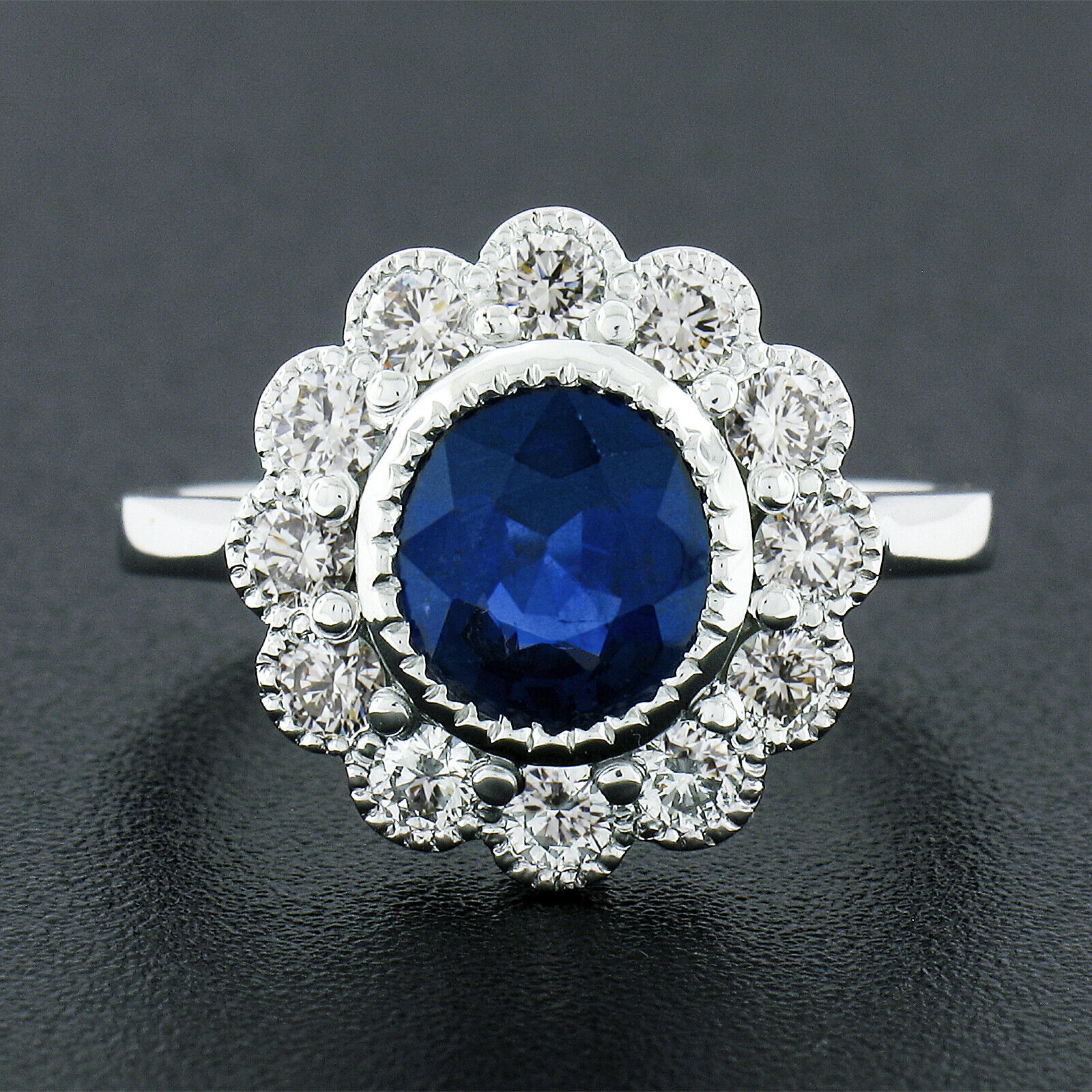 This truly breathtaking engagement or cocktail ring is newly crafted in solid platinum and features a TOP QUALITY, GIA certified, sapphire at its center. The beautiful gemstone has an oval brilliant cut and displays the most gorgeous and velvety