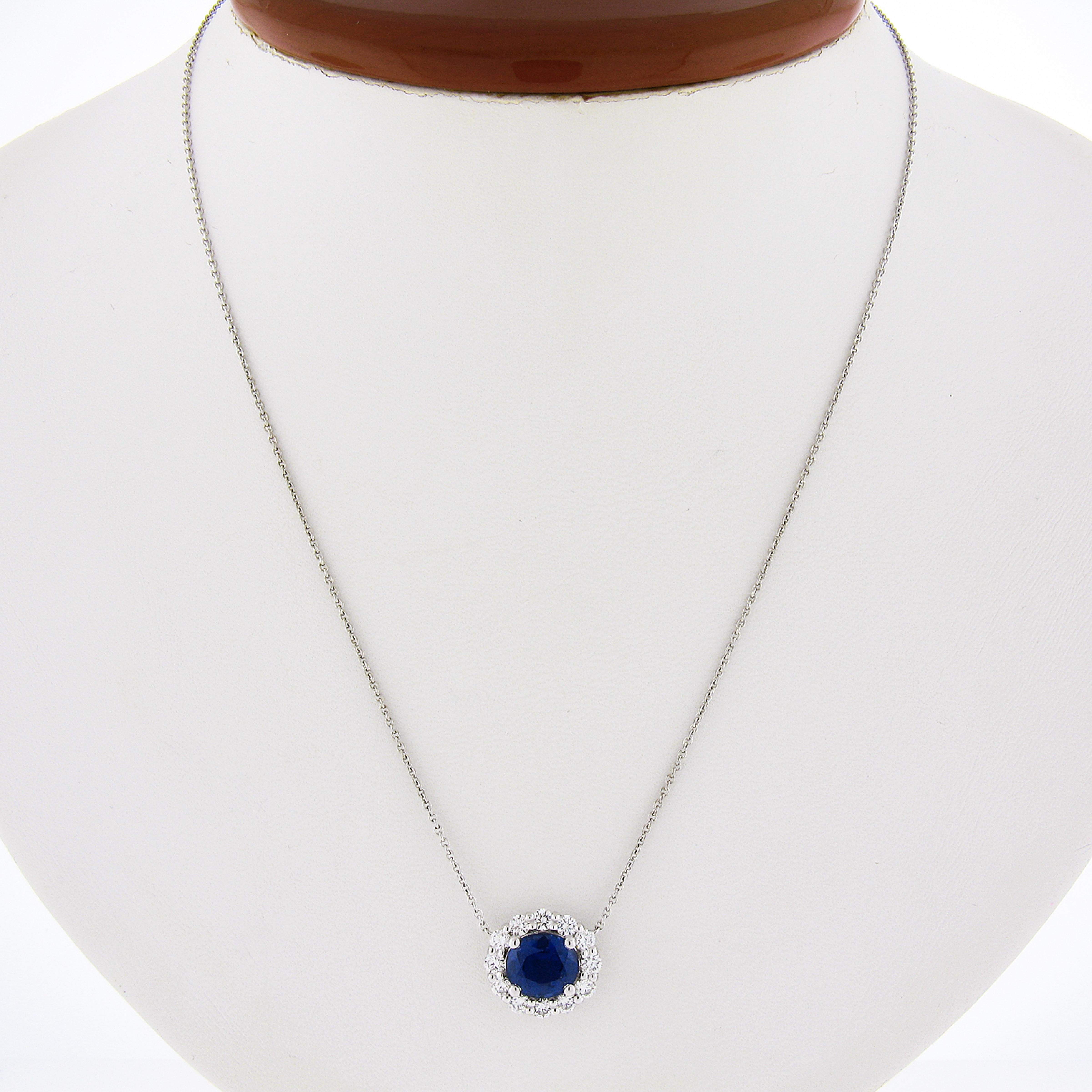 This custom made sapphire and diamond necklace features a truly magnificent royal blue oval brilliant cut sapphire certified by GIA. This mesmerizing blue sapphire is surrounded by a halo of fine quality diamonds that add a fancy and elegant touch
