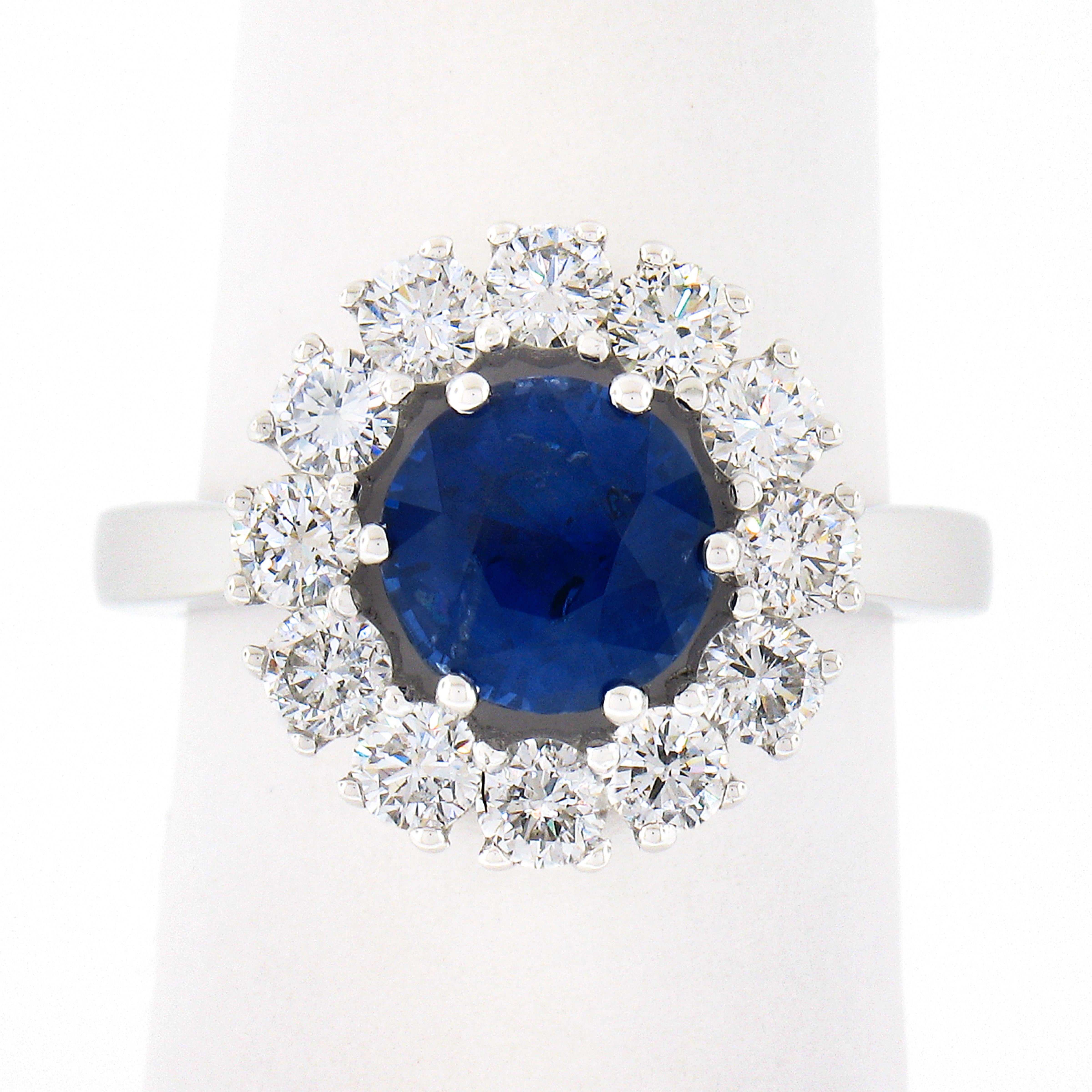 You are looking at a truly magnificent and very well made sapphire and diamond cocktail ring that is newly crafted from solid platinum. The ring features a rare round brilliant cut sapphire that is elegantly prong set at the center of a brilliant