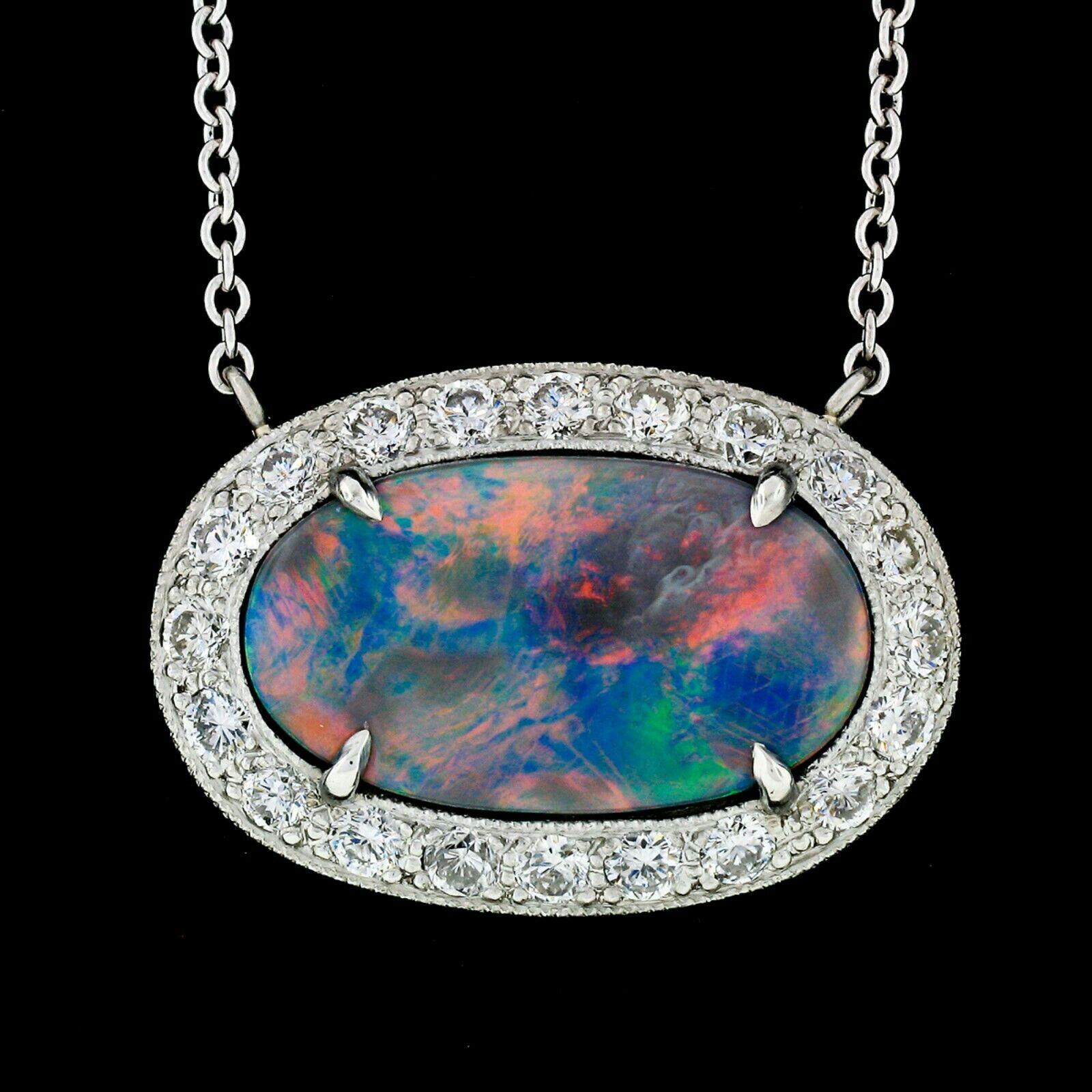 Here we have an absolutely magnificent pendant that has been newly custom made from solid .950 platinum. The pendant features a gorgeous GIA certified gray opal that is 100% natural and weighs exactly 5.19 carats. The oval cut stone has a
