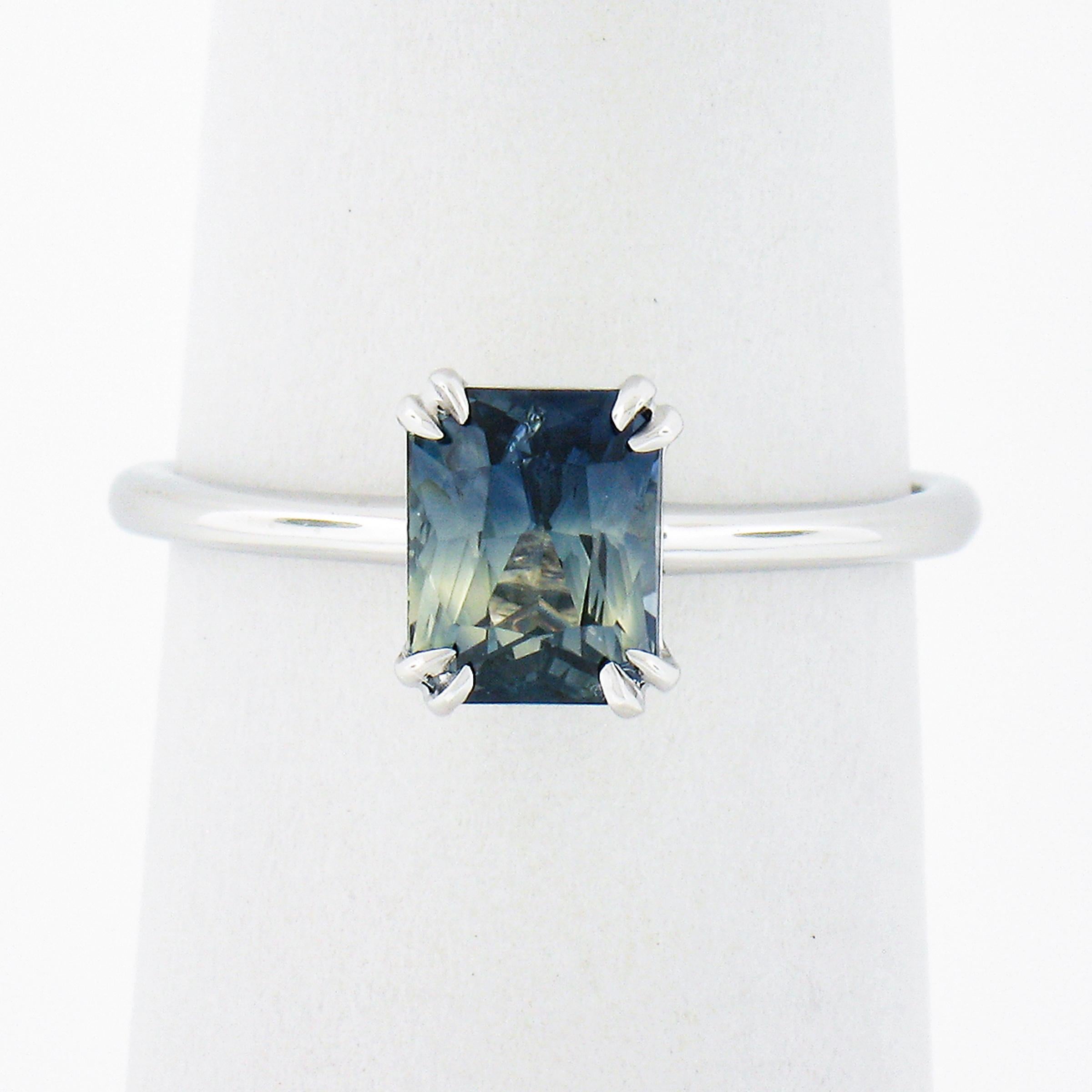 This classic solitaire ring is newly crafted from solid platinum and features a stunning, GIA certified, octagonal cut natural sapphire stone, elegantly double claw prong set at the center. This gorgeous and unique stone shows naturally zoned blue