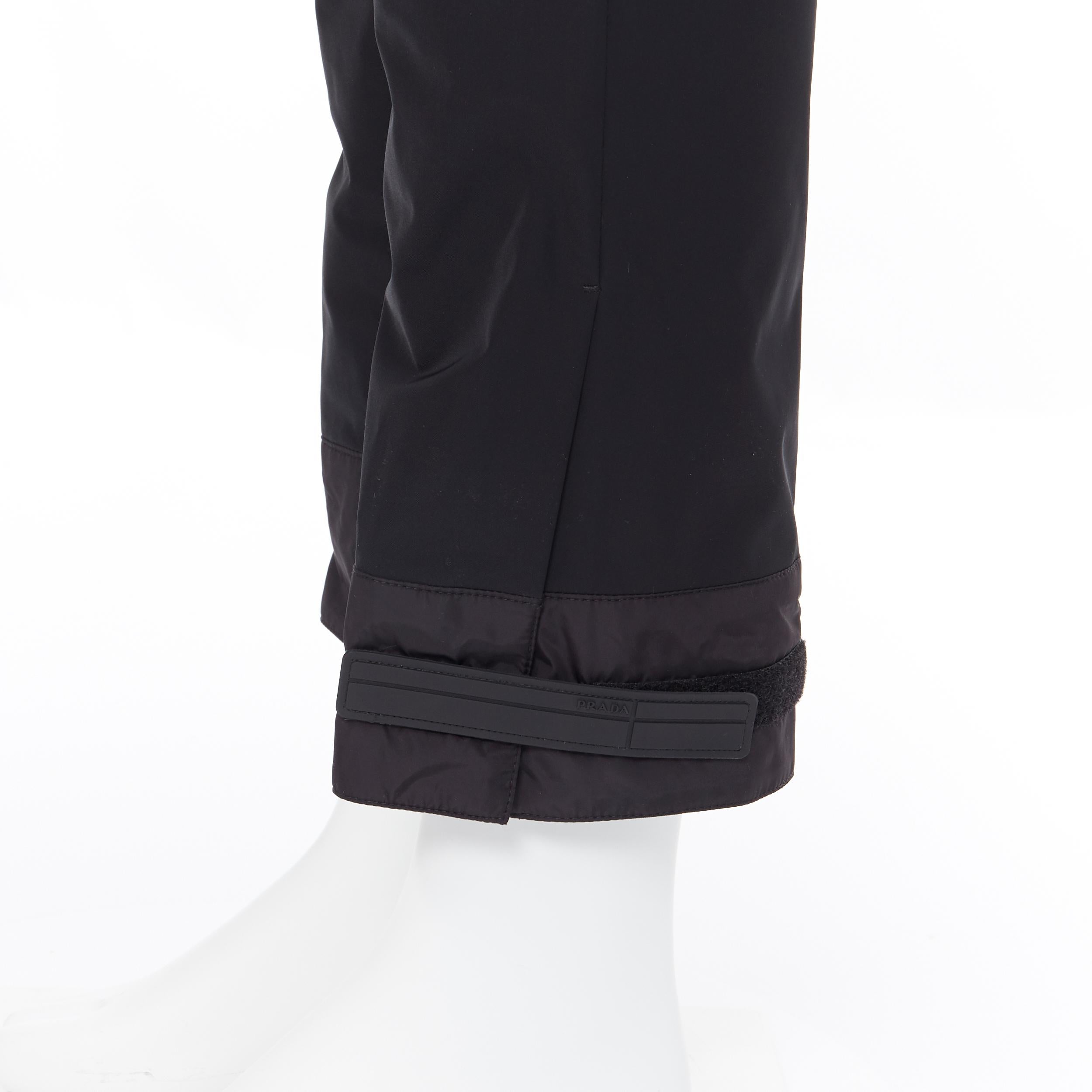 new PRADA 2018 black sportswear logo cuff hem track pants trousers IT48 M
Brand: Prada
Designer: Miuccia Prada
Collection: Fall Winter 2018
Model Name / Style: Cuff trousers 
Material: Polyester
Color: Black
Pattern: Solid
Closure: Zip
Extra Detail: