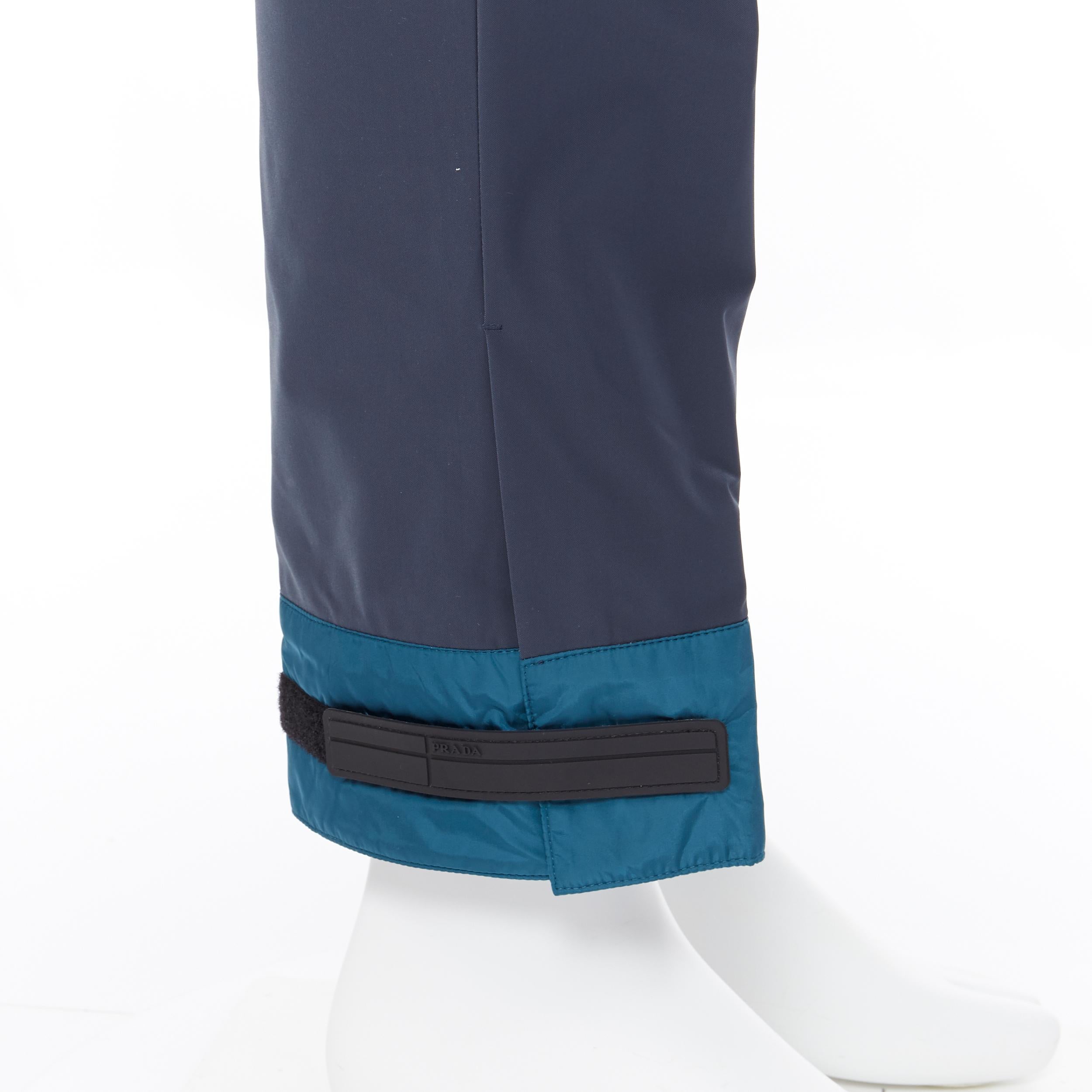 new PRADA 2018 black sportswear logo cuff hem track pants trousers IT52 XL
Brand: Prada
Designer: Miuccia Prada
Collection: Fall Winter 2018
Model Name / Style: Cuff trousers 
Material: Polyester
Color: Blue
Pattern: Solid
Closure: Zip
Extra Detail: