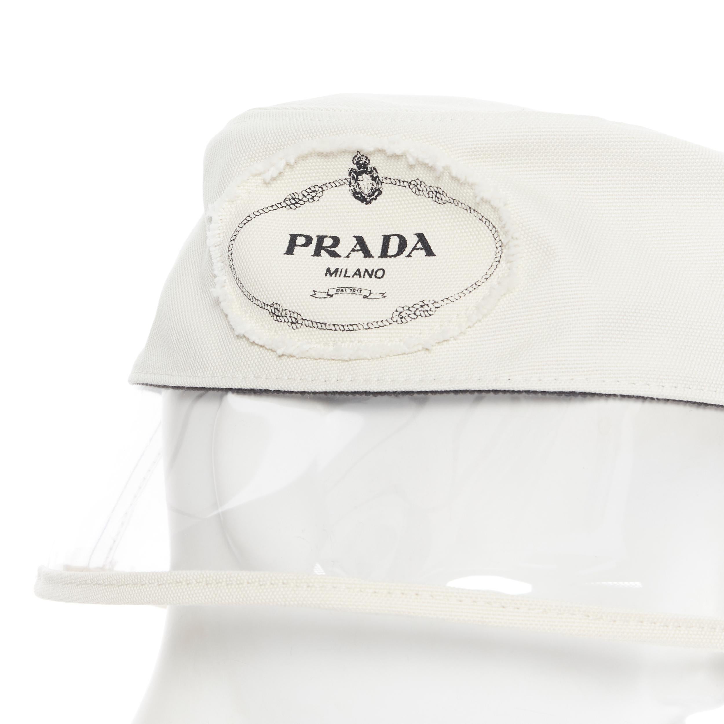 new PRADA 2018 cream cotton frayed logo clear PVC brim shield 90's bucket hat M
Brand: Prada
Designer: Miuccia Prada
Collection: Spring Summer 2018
Model Name / Style: Bucket hat
Material: Cotton, PVC
Color: White
Pattern: Solid
Extra Detail: Very