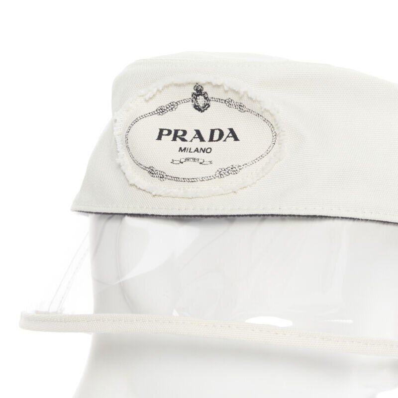 new PRADA 2018 cream cotton frayed logo clear PVC brim shield 90's bucket hat M
Reference: TGAS/A05971
Brand: Prada
Designer: Miuccia Prada
Collection: Spring Summer 2018 Tribute Collection
Material: Cotton, PVC
Color: White
Pattern: Solid
Extra