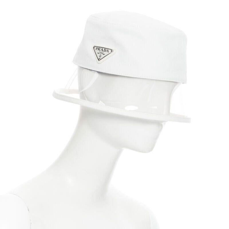 new PRADA 2018 cream cotton triangle logo clear PVC brim 90's bucket hat S
Reference: TGAS/A06017
Brand: Prada
Designer: Miuccia Prada
Model: Bucket hat
Collection: Spring Summer 2018 Tribute Collection
Material: Cotton, PVC
Color: White
Pattern: