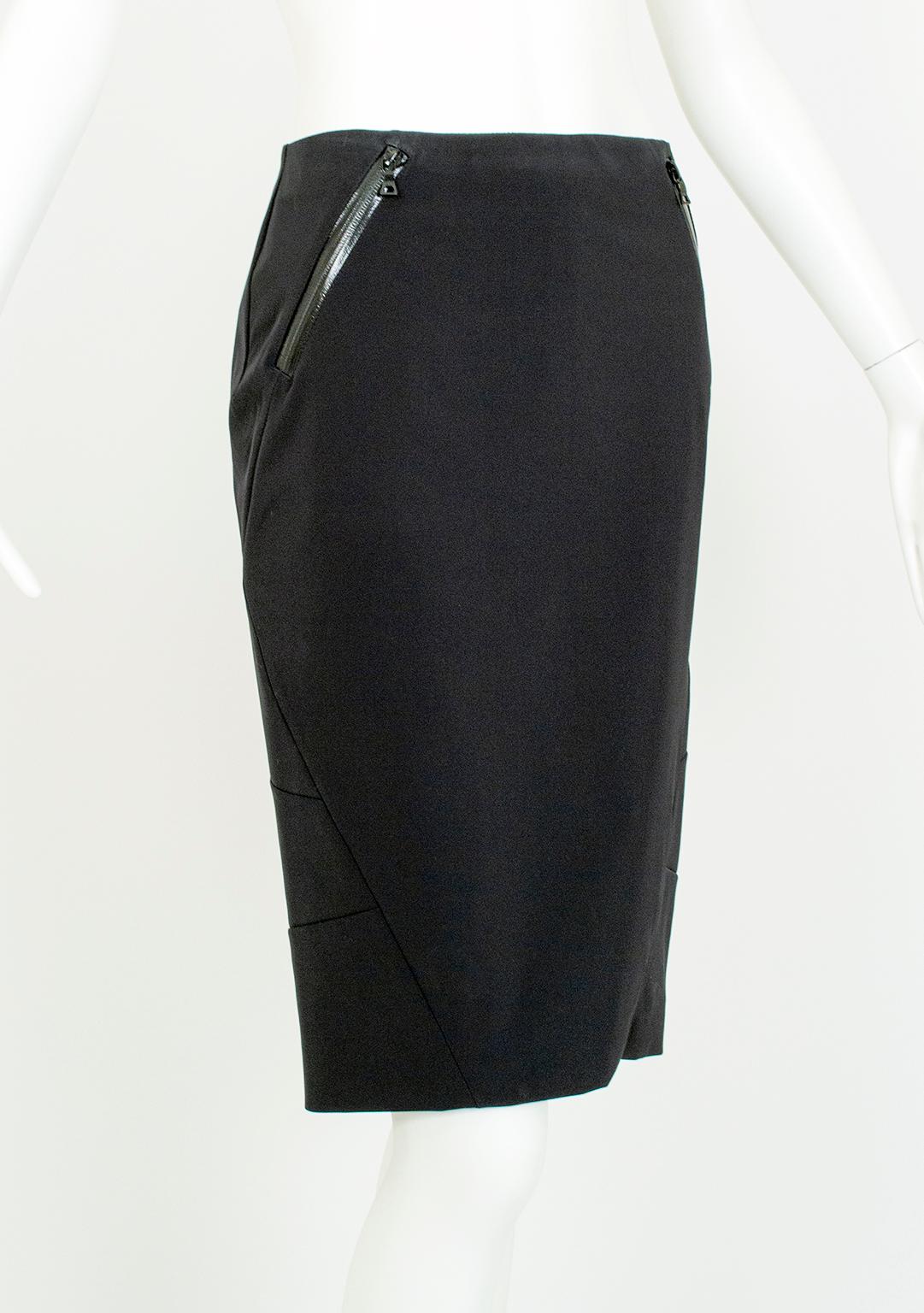At once both devastatingly sexy and still powerfully professional, this pencil skirt combines trompe-l’oeil corset seams and shiny vinyl-trimmed zippers for a gentle dominatrix effect. The rear zippered vent can be kept fully closed for a hobble