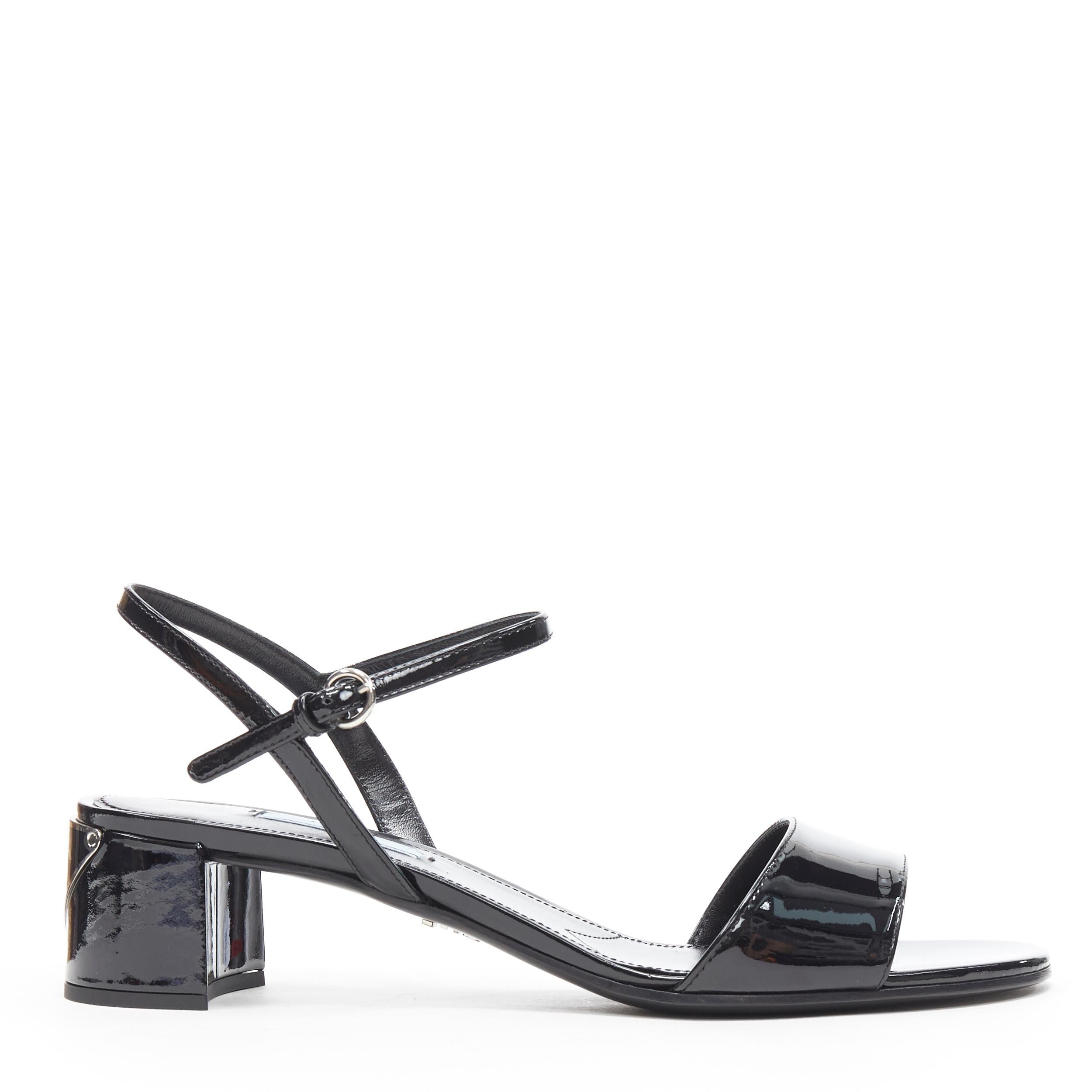 new PRADA black patent silver triangle brand logo plate mid heel sandal EU38 
Reference: TGAS/B00108 
Brand: Prada 
Designer: Miuccia Prada 
Model: Kitten heel 
Material: Patent leather 
Color: Black 
Pattern: Solid Extra 
Detail: Black patent